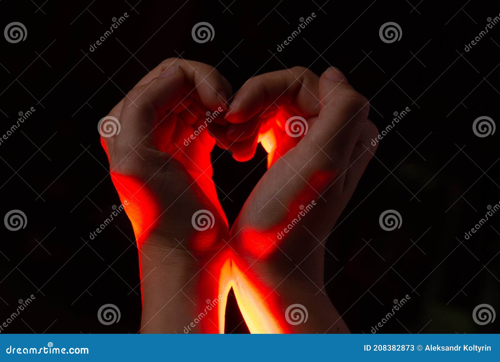 two hands folded in the  of a heart, light inside. clench your hands,  of love.