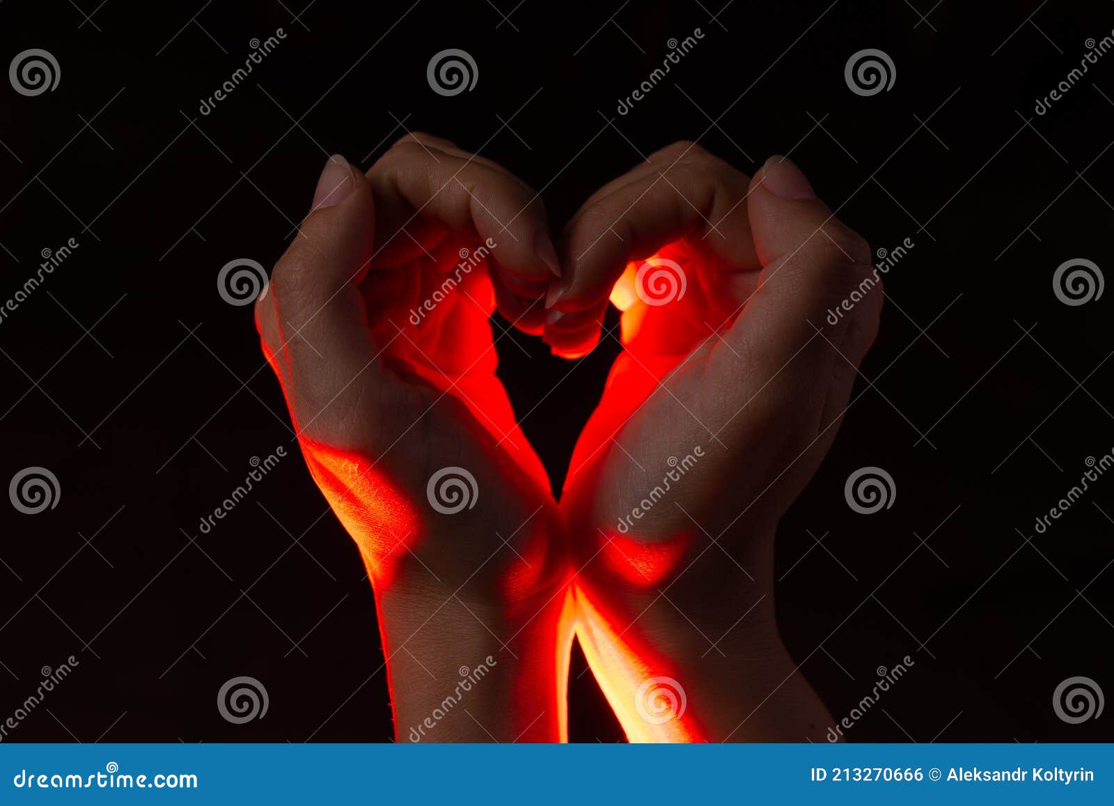 two hands folded in the  of a heart, light inside. clench your hands,  of love.