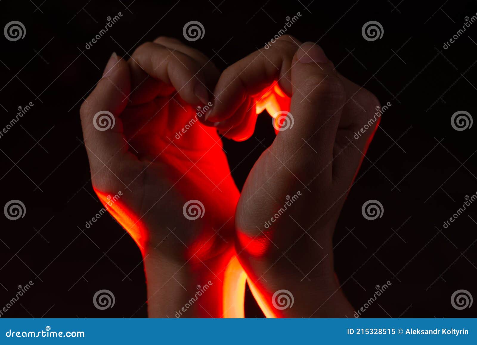 two hands folded in the  of a heart, light inside. clench your hands,  of love.