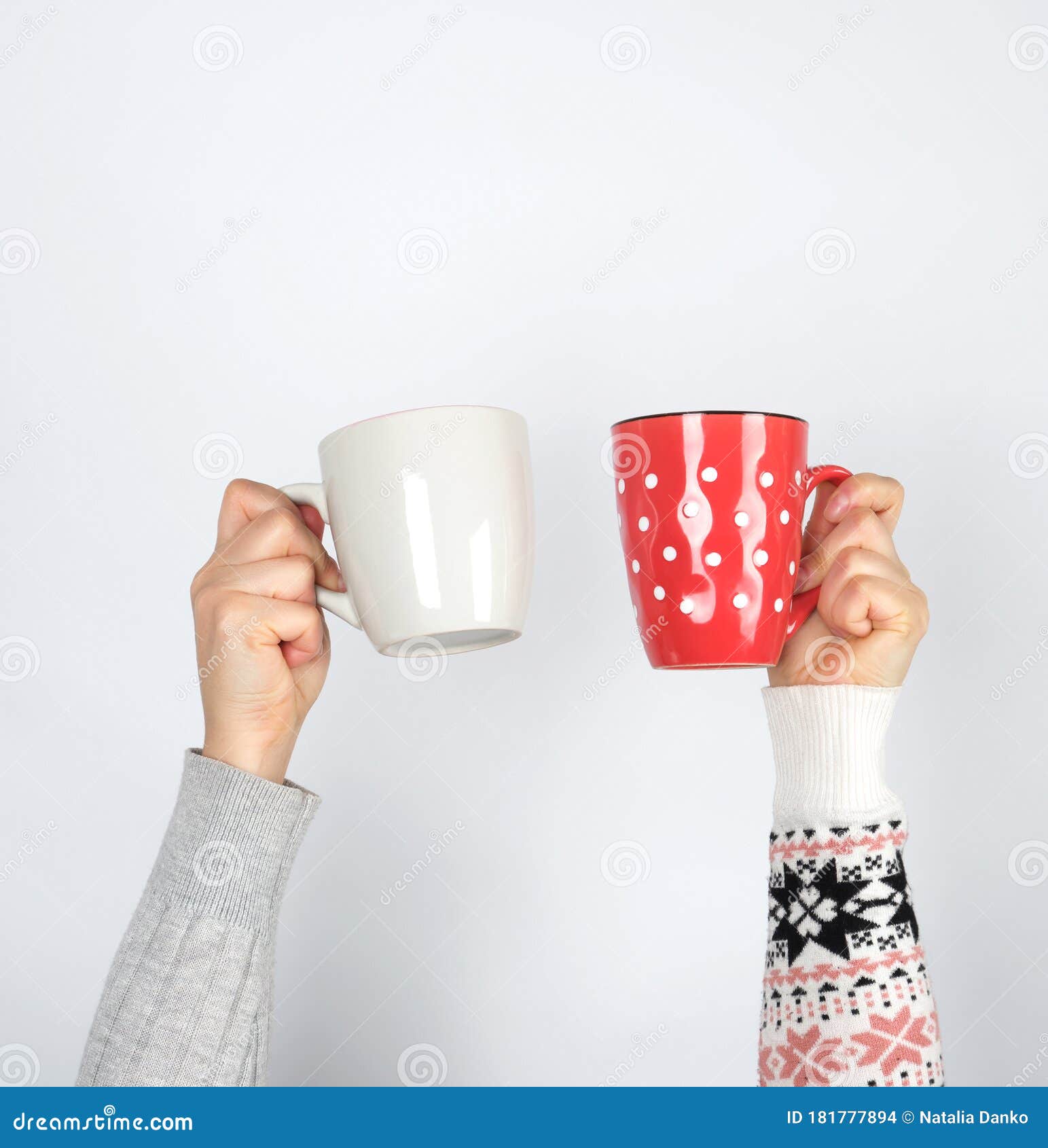 Two Hands Holding Ceramic Mugs On A White Background, Copy Space Stock