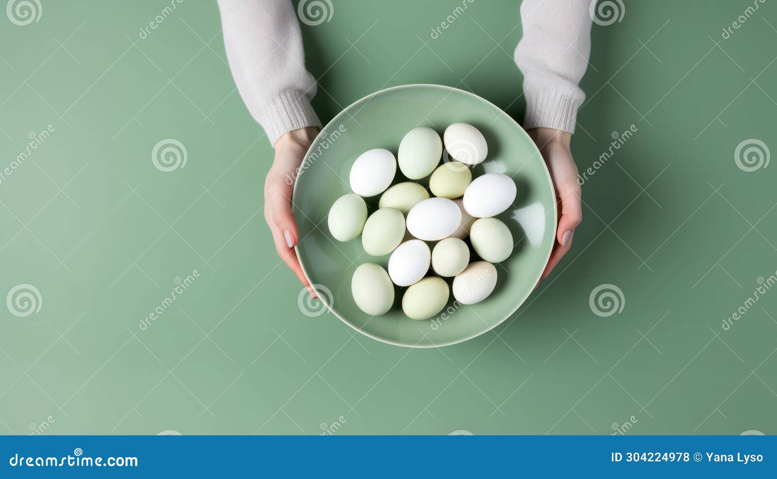 two hands holding a light green plate filled with pale-hued eggs against a green background, suitable for easter and