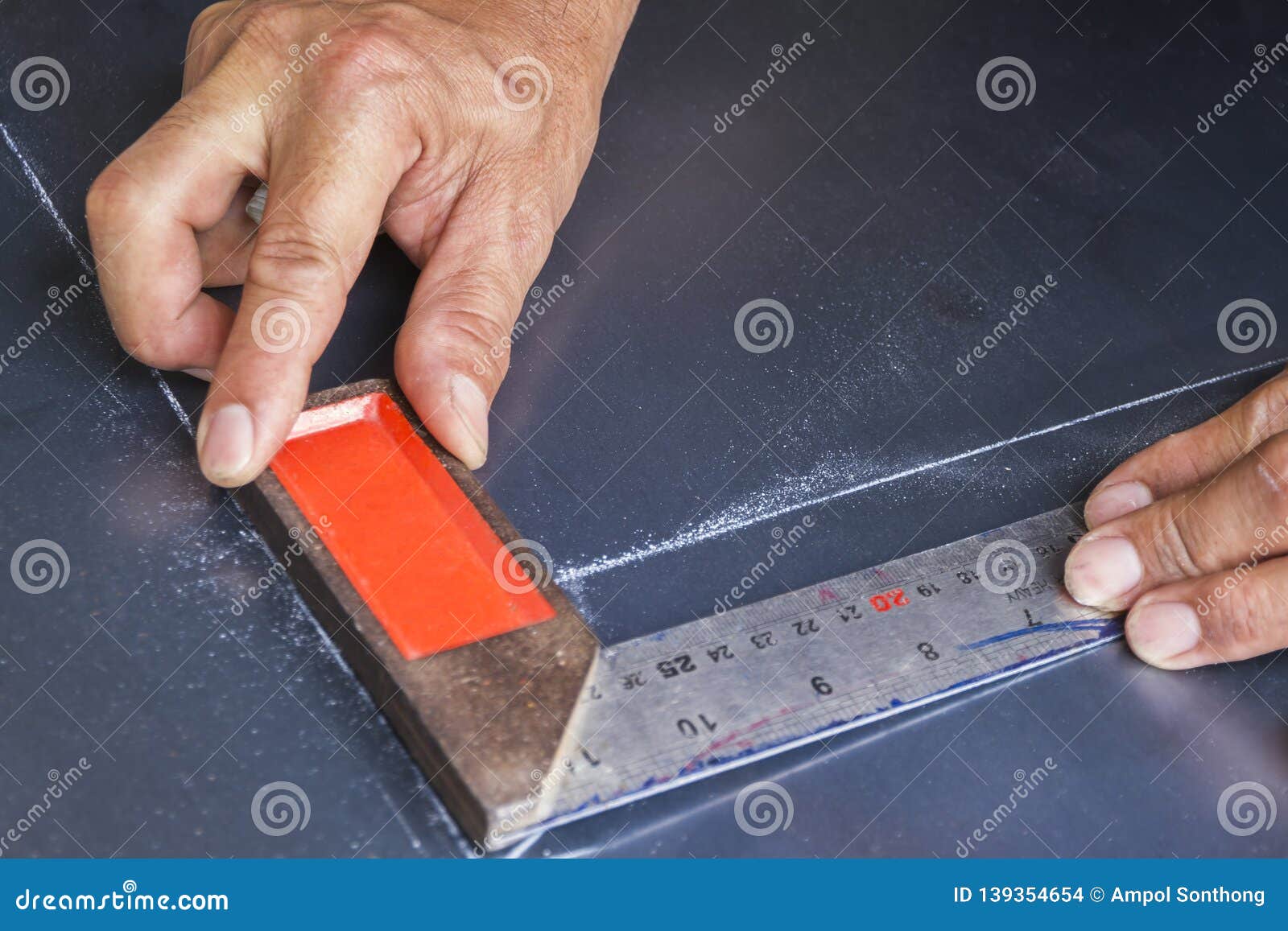 Two Hands Keep Metal Angle on Steel Plate. Stock Photo Image of