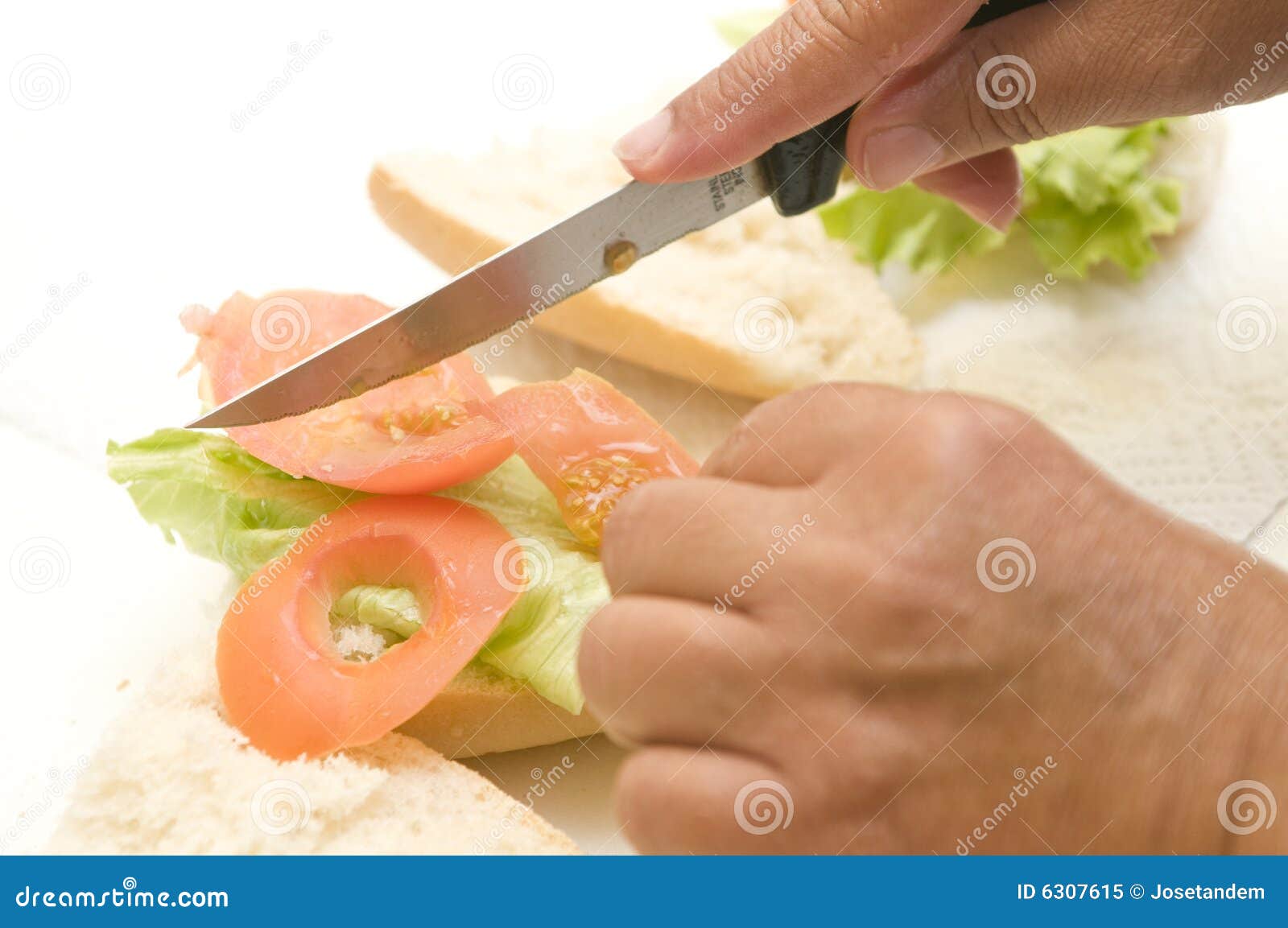 two hands making a vegetal sandwich