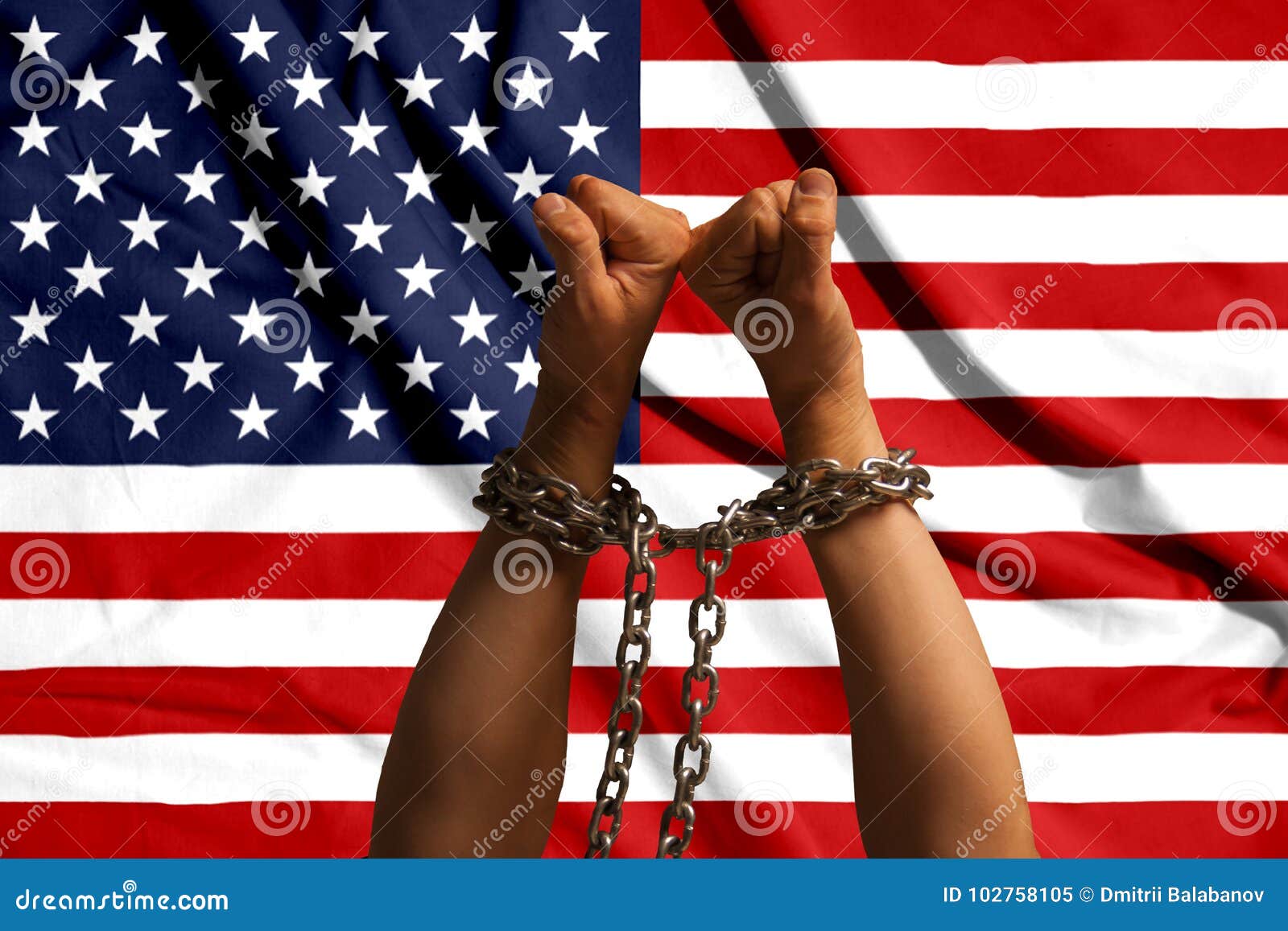 Two Hands Shackled a Metal Chain on the Background of the USA Flag