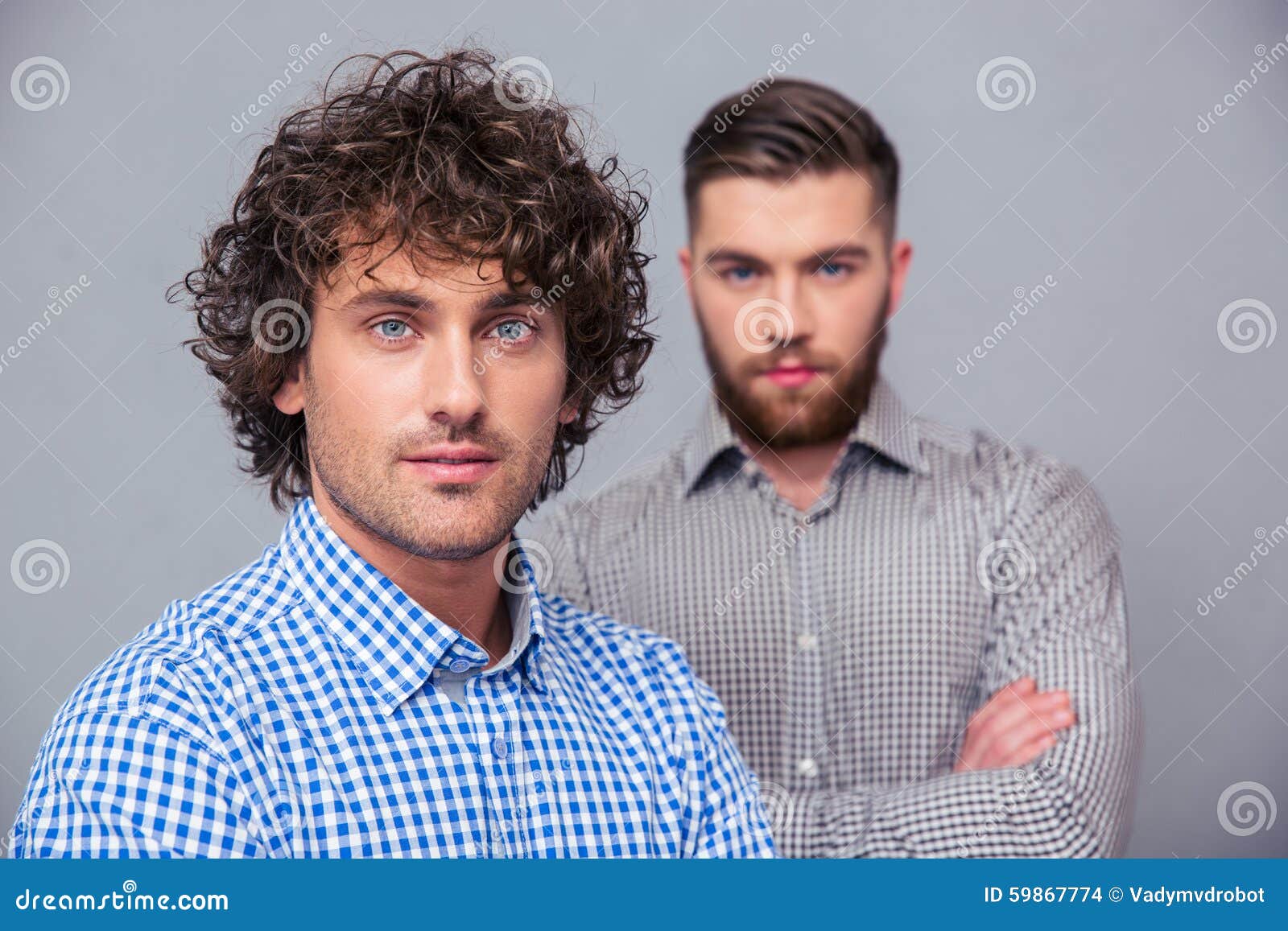 Two Handsome Businessmen Standing With Arms Folded Stock Photo - Image ...