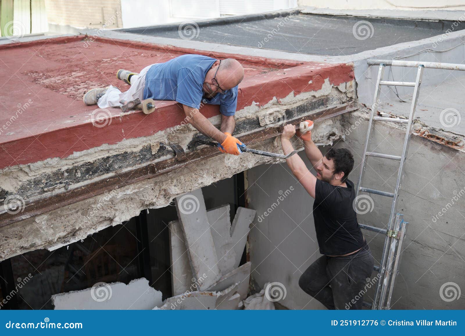Two Handymen Removing Old Metal Beams in a Construction House. Stock Photo Image of destroying