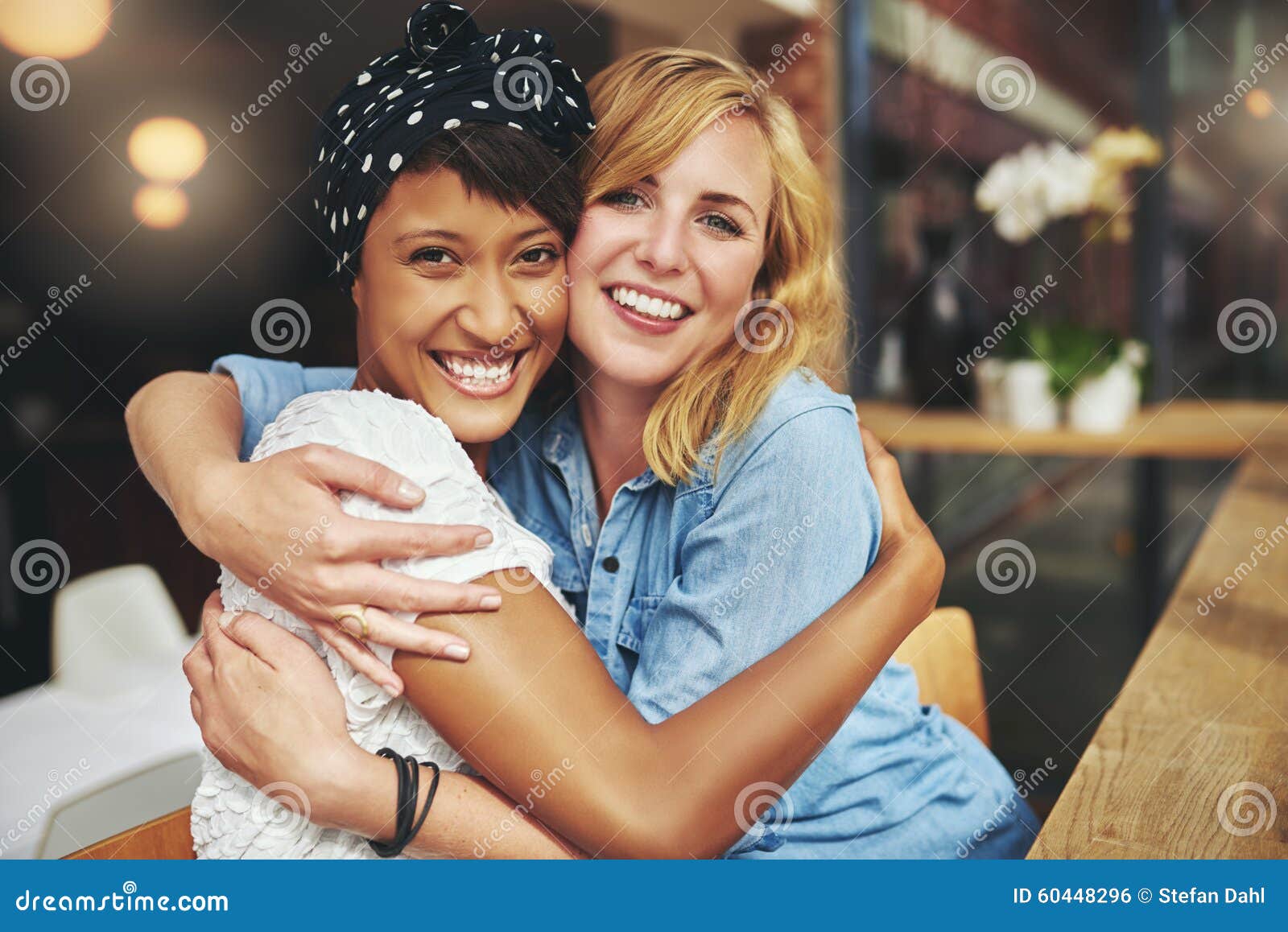 two happy affectionate young woman hugging