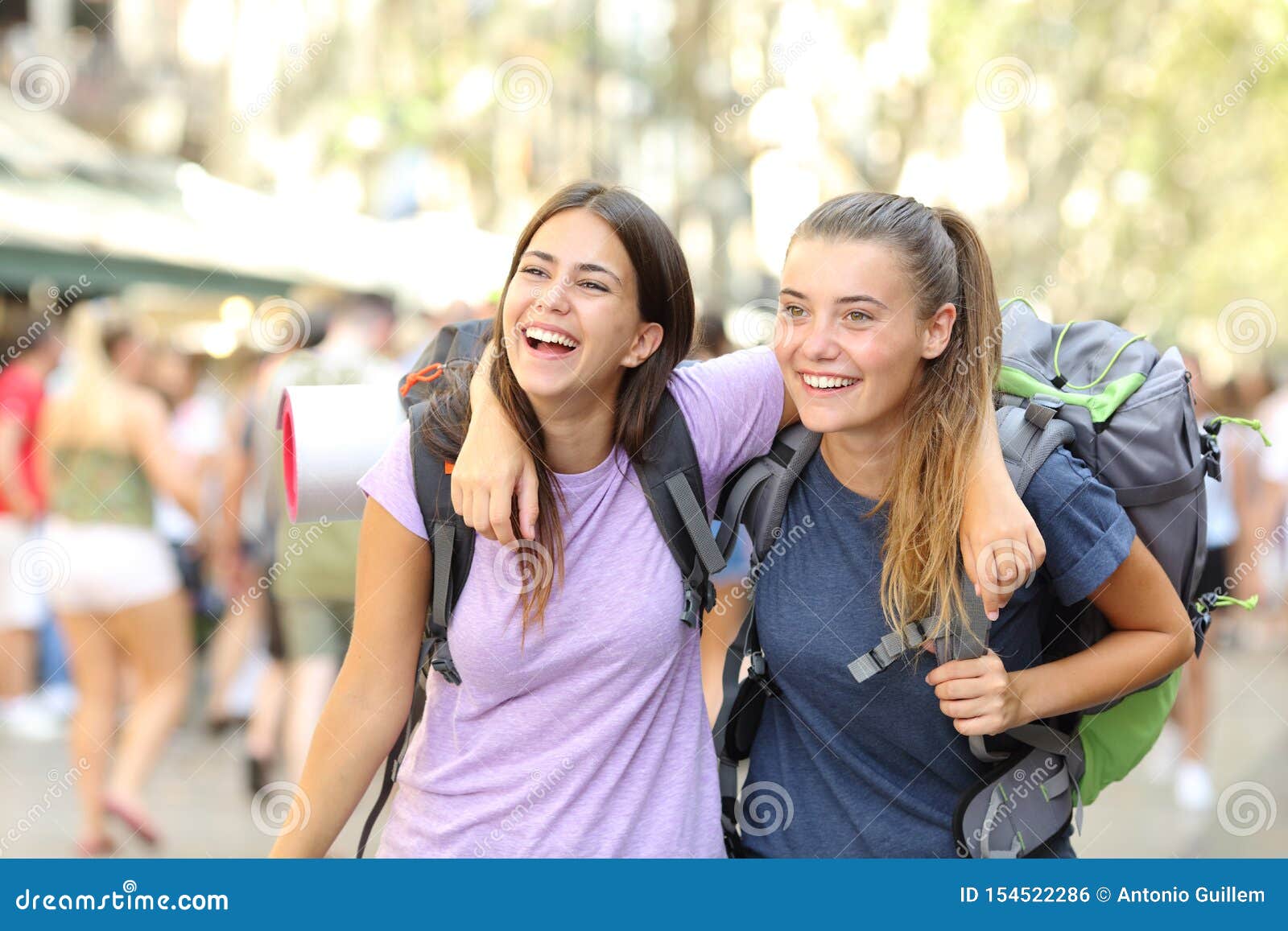 two happy backpackers laughing enjoying vacation