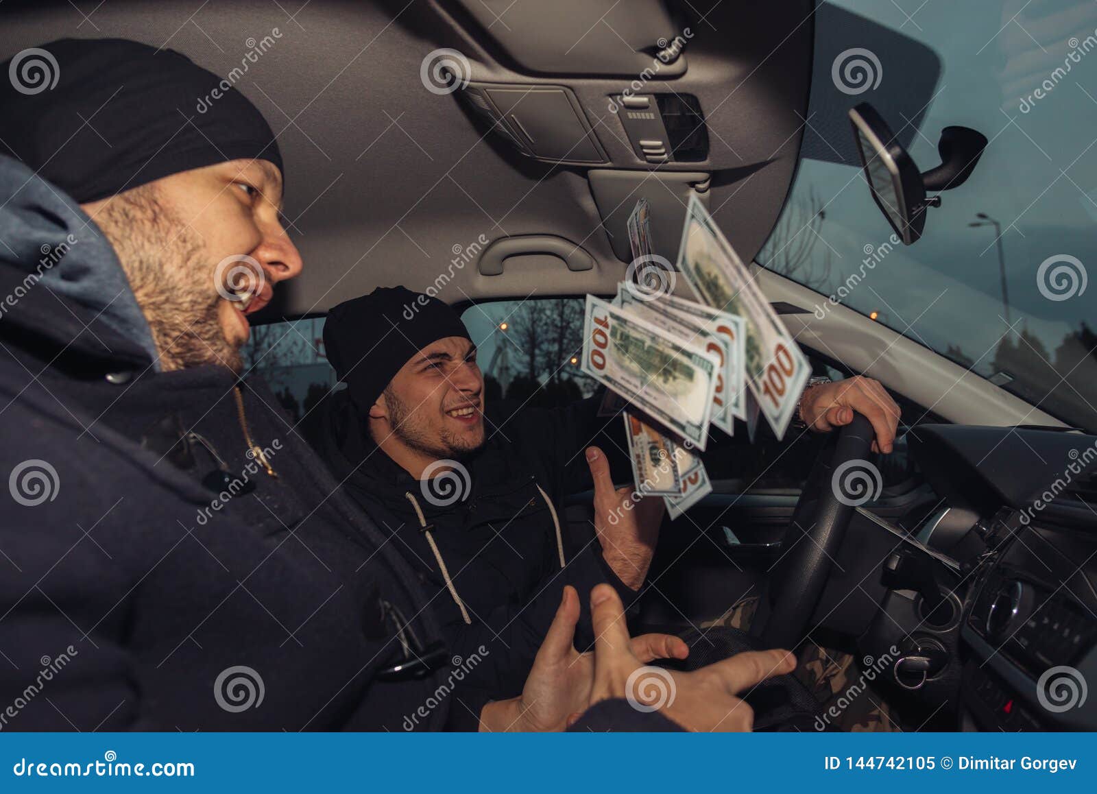 Two Happy Bank Robbers Celebrating Their Successful Hit While Sitting