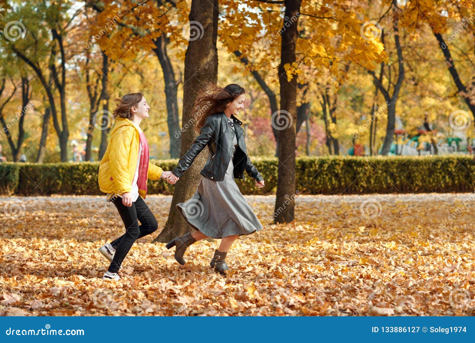 Two Happy Girls Running in Autumn City Park Stock Image - Image of ...