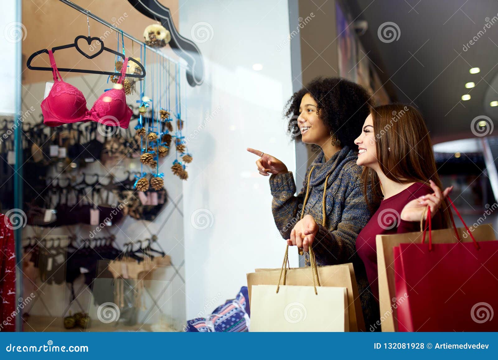 Two Happy Multiethnic Young Mixed Race Woman Shopping for Lingerie Near  Clothing Boutique Shop Window, Decide Whether To Stock Photo - Image of  african, black: 132081928