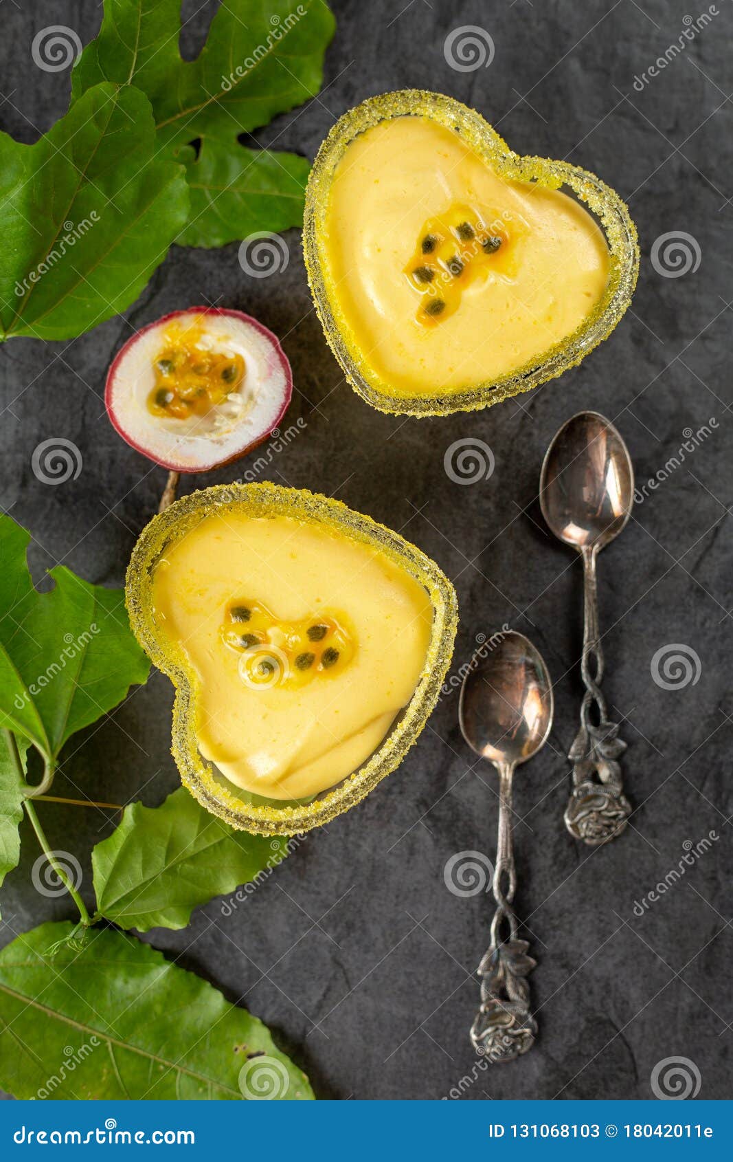 Two Heart Shaped Ramekin with Passion Fruit Mousse on Dark Background