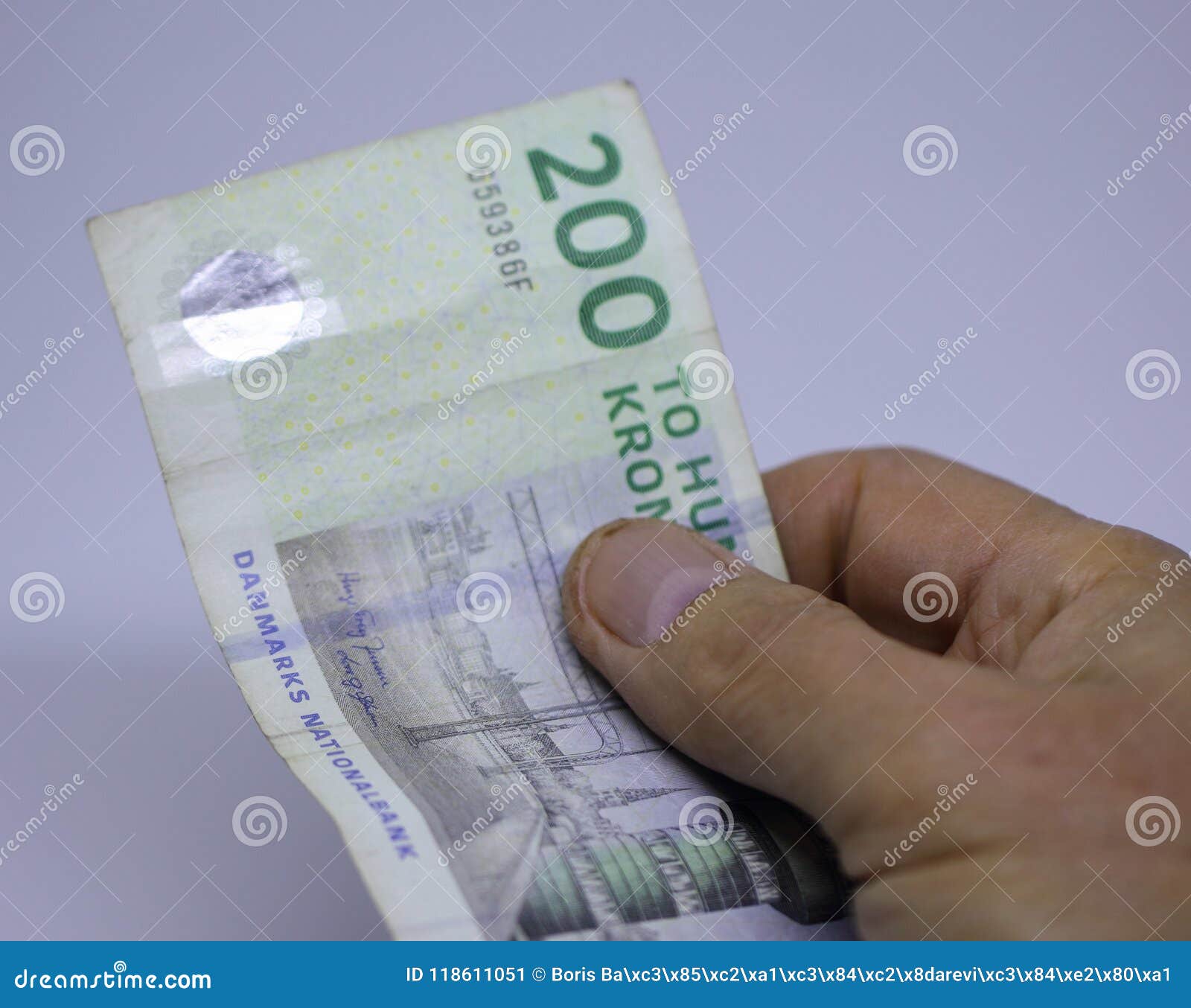 Two Hundred Danish Kroner Banknote in a Hand. Stock Image of funds, hand: 118611051