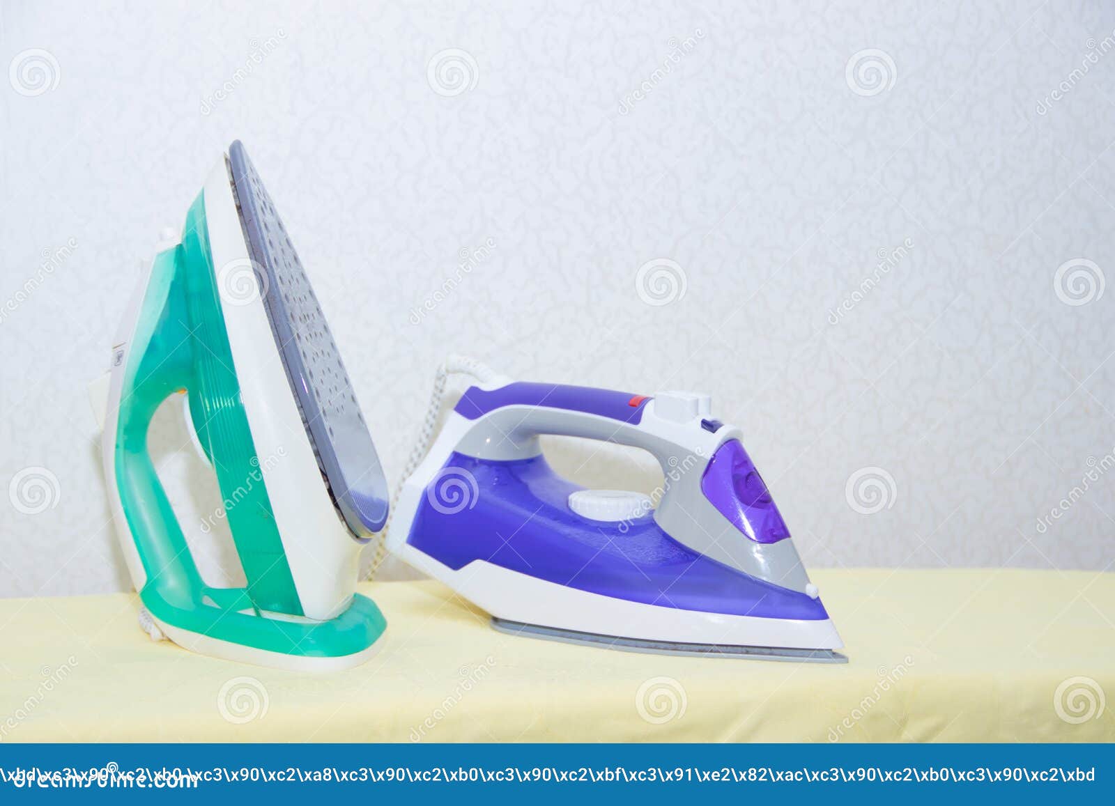 Two Irons on an Ironing Board. Selection and Comparison of Irons. Ironing Board Stock Photo