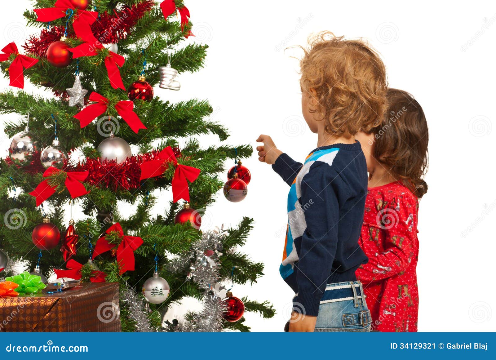 two kids decorate christmas tree