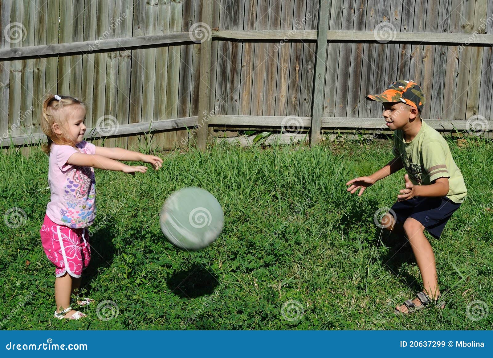 two kids playing ball backyard 20637299