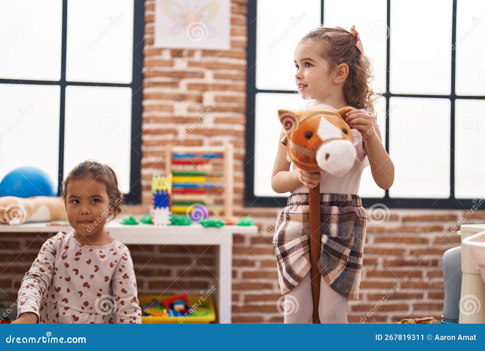 Two Kids Playing with Horse Toy at Kindergarten Stock Image Image of