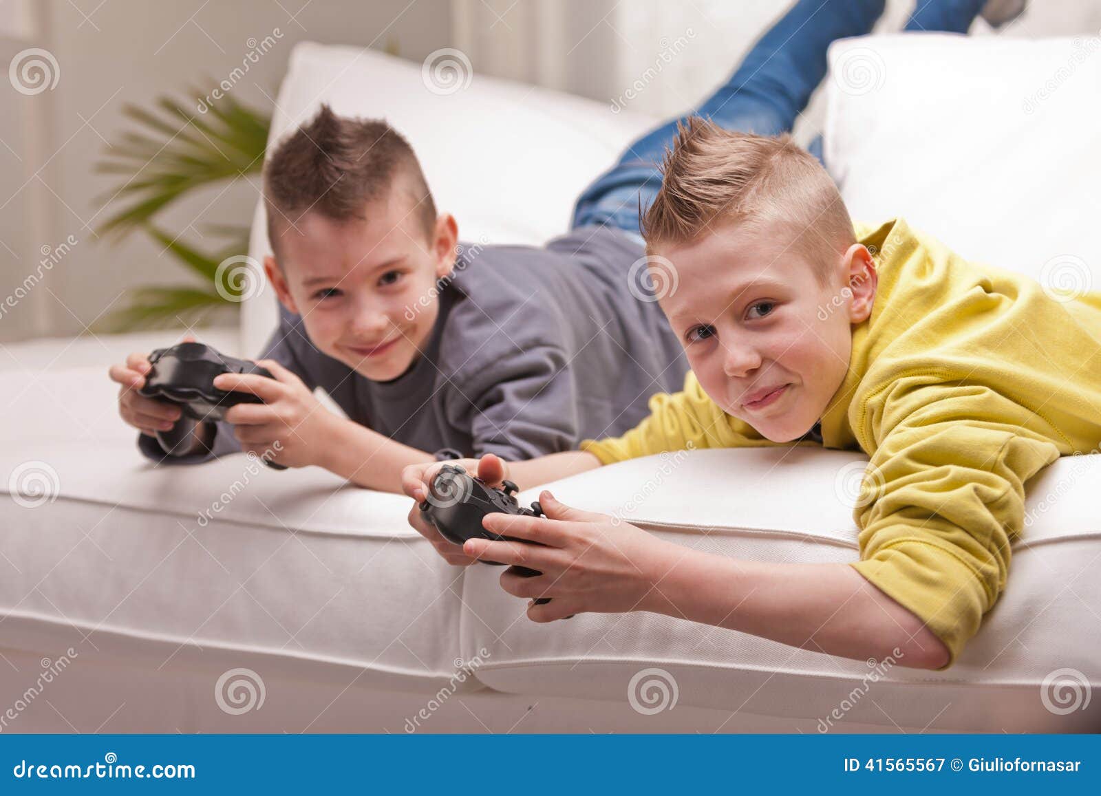 Young People Playing Video Games At Home Stock Photo, Picture and Royalty  Free Image. Image 113583143.