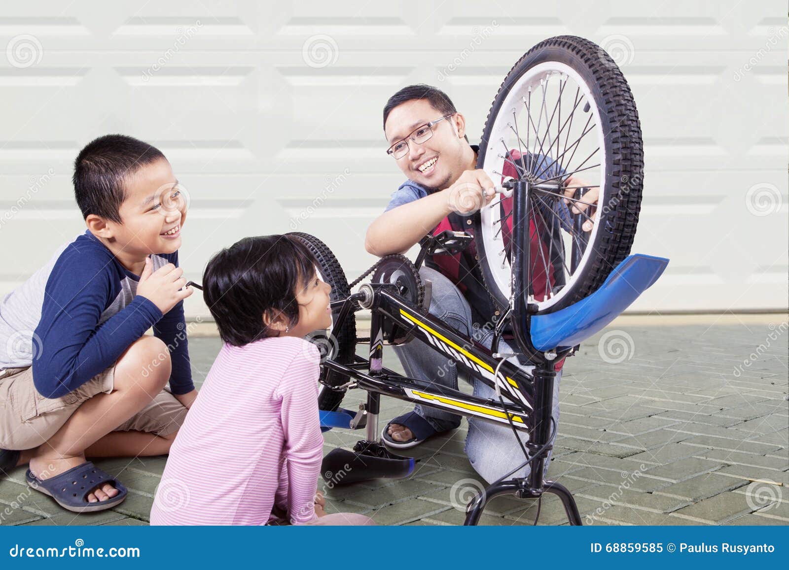 Two Kids Repair Bicycle with Dad Stock Image - Image of home, equipment