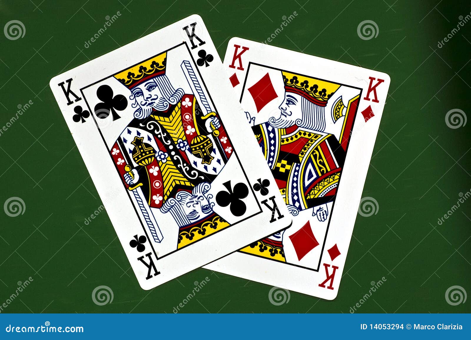 Hand in foreground holding pair of kings in poker