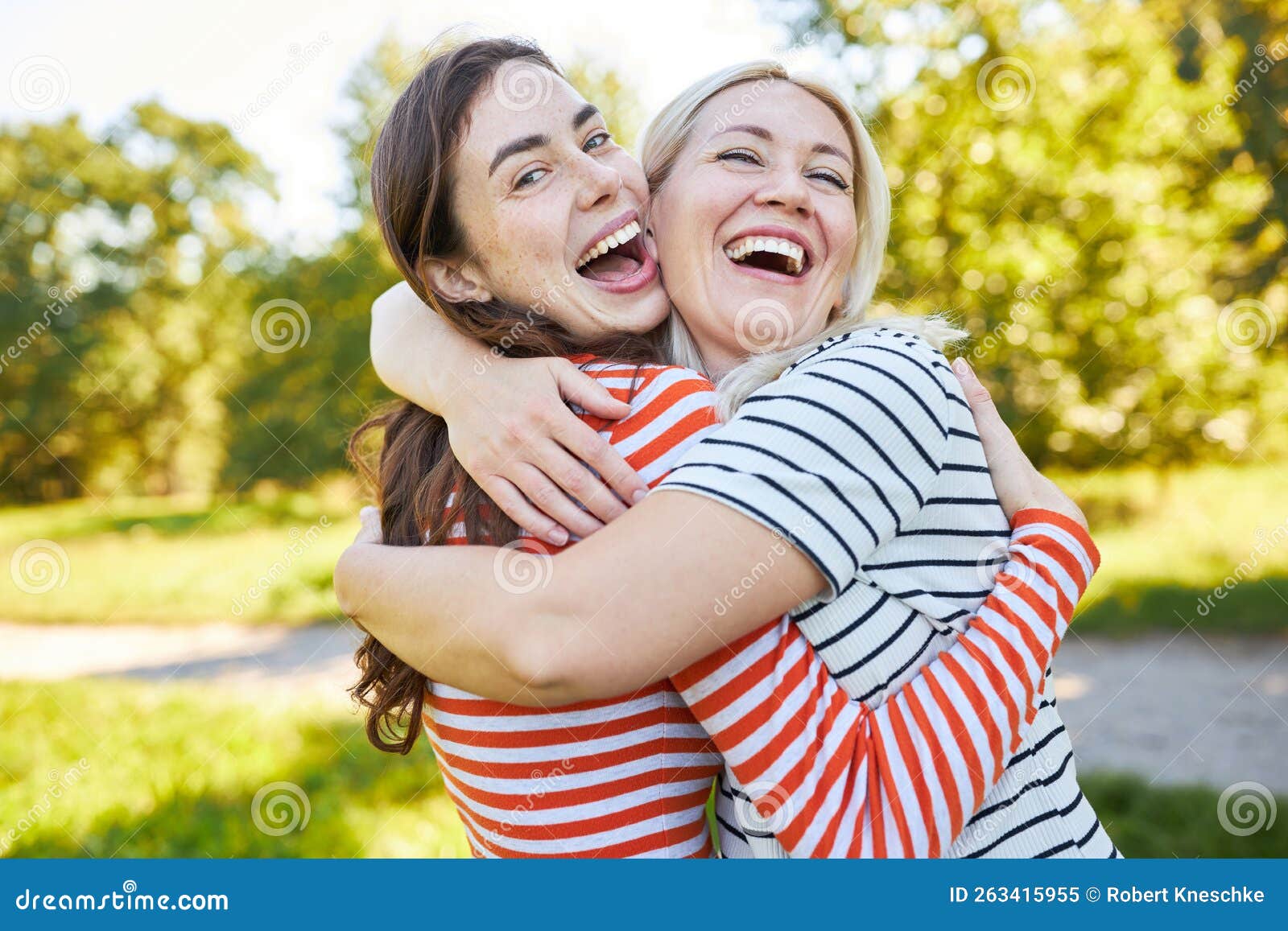 Two Laughing Friends Hug Each Other In Nature Stock Image Image Of