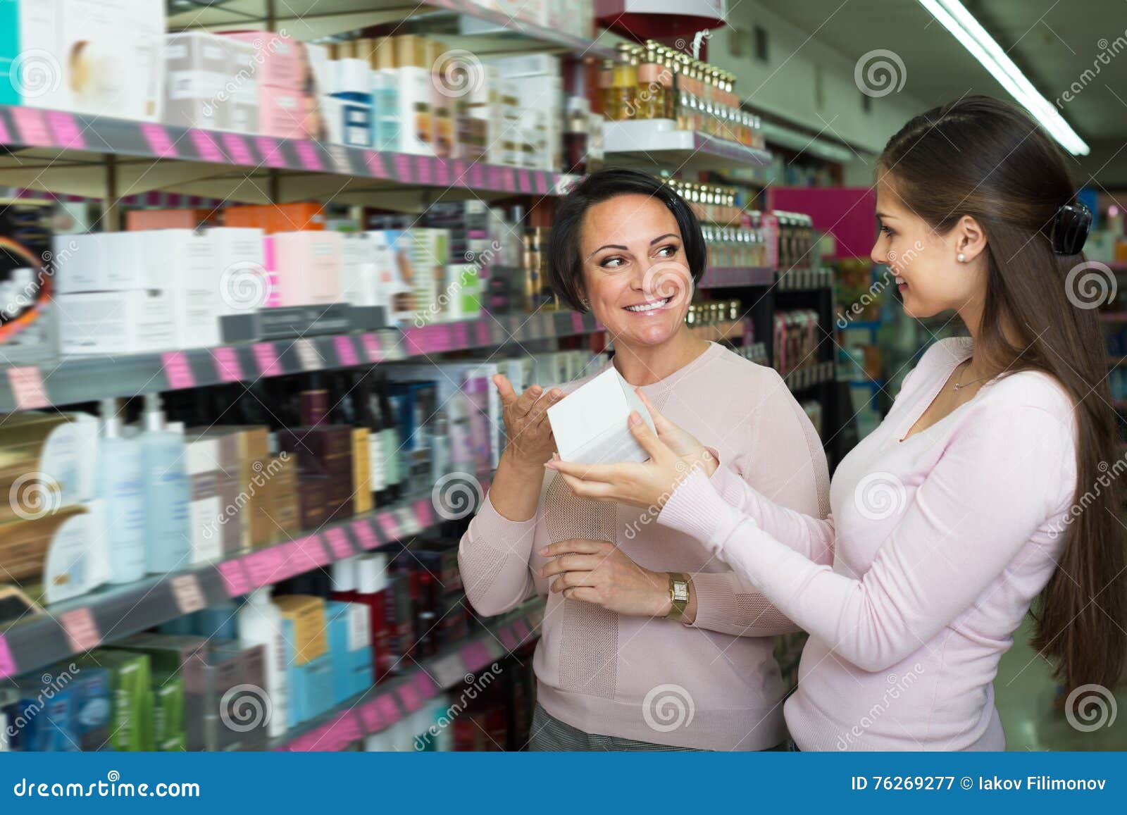 Two Laughing Women Picking Cream From Shelf Stock Image Image Of Choosing Mature 76269277