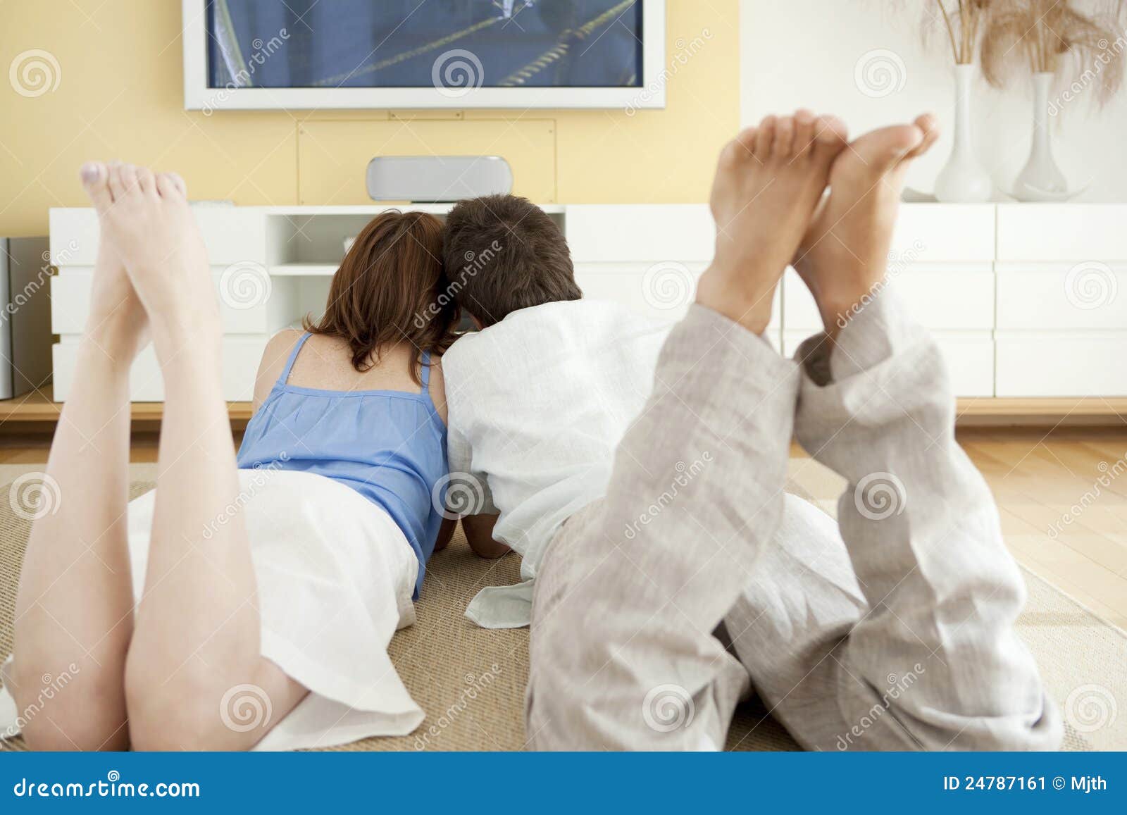 Two Laying Down On Floor Watching TV Stock Image Image of girlfriend, floor 24787161