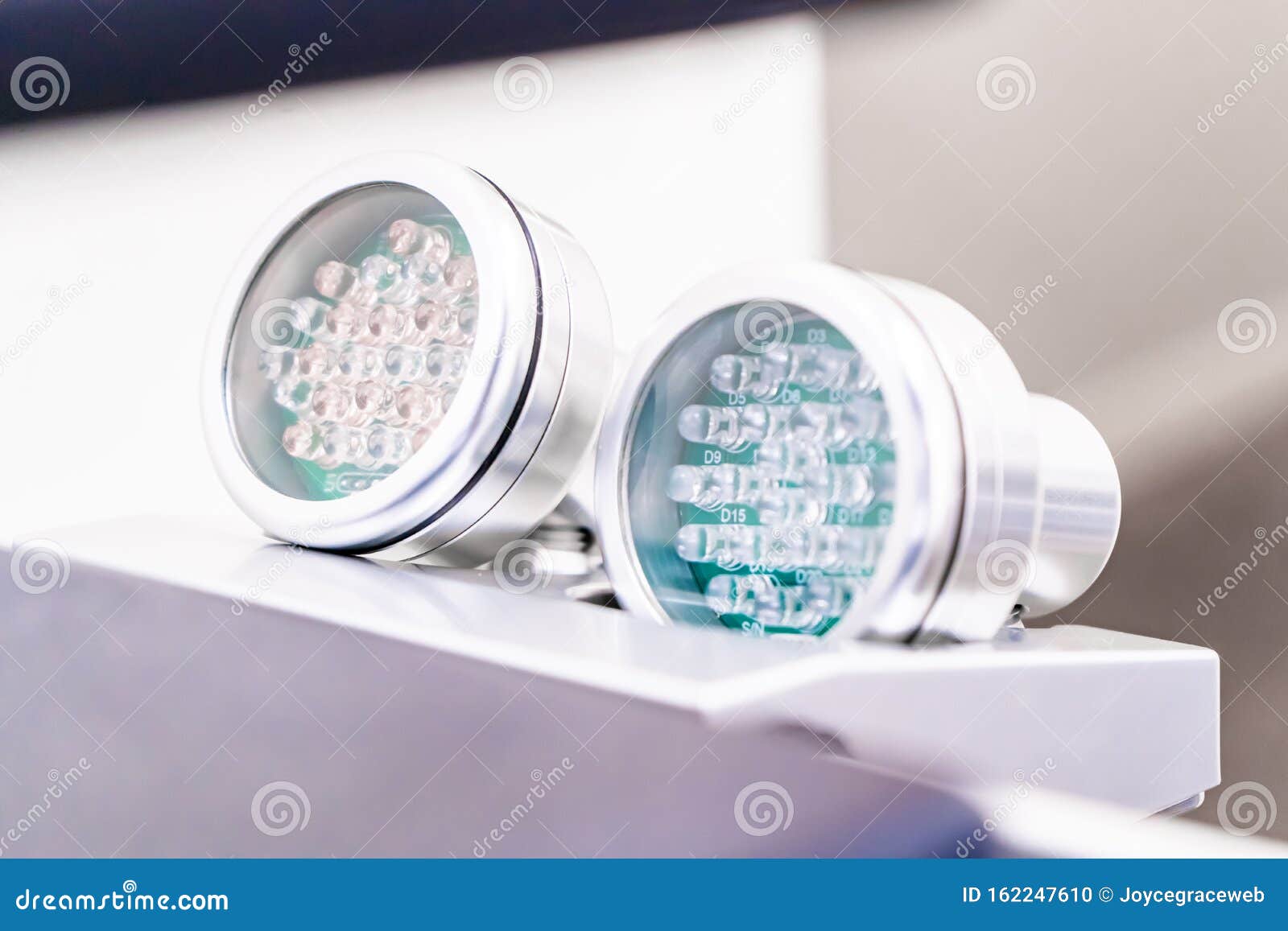 two led light therapies for skin, on handles, showing light bulbs. red led light for anti-aging and skin smoothing treatment and