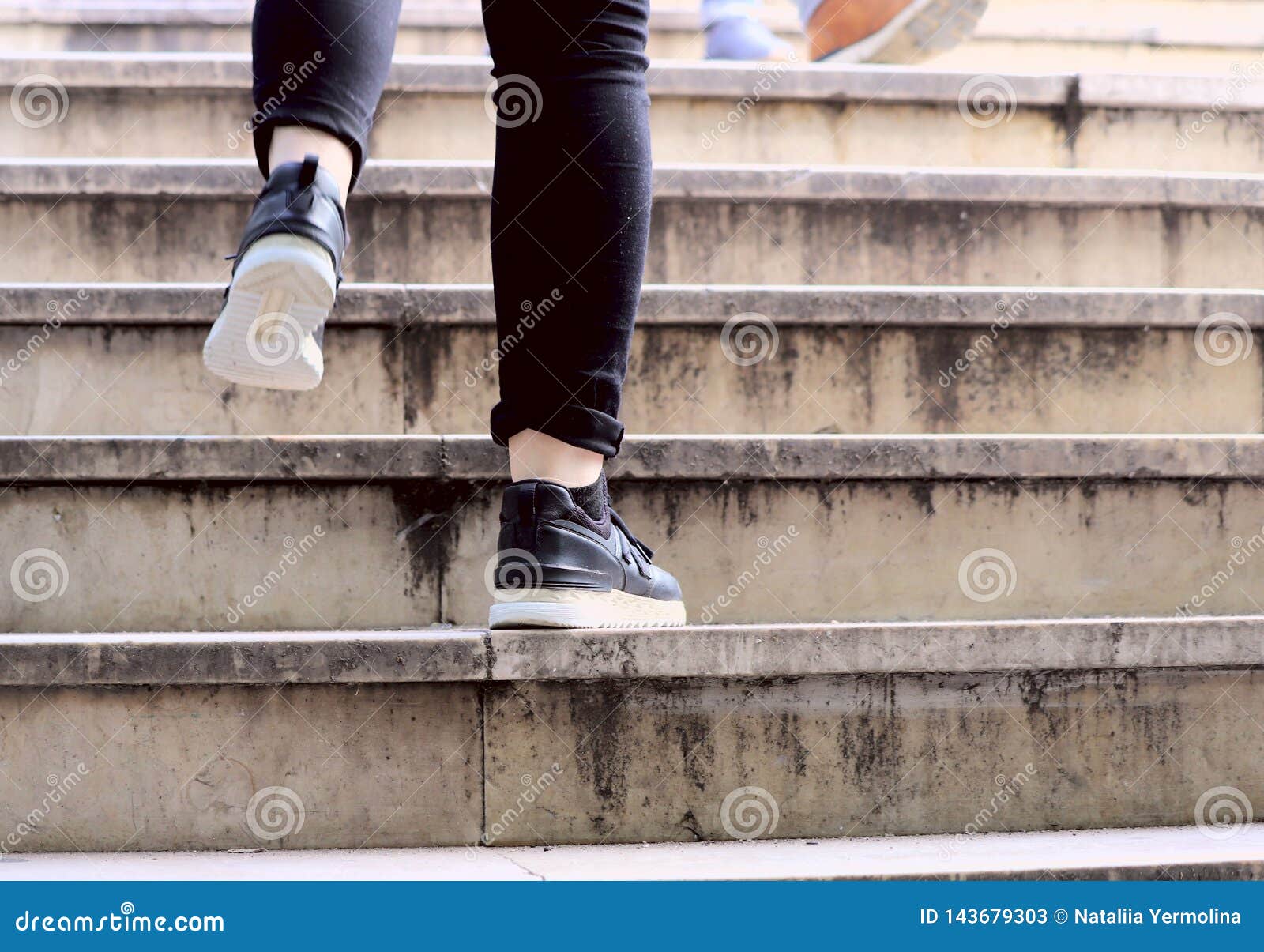 Two Legs of a Person in Sneakers Climbing the Stairs Stock Image ...