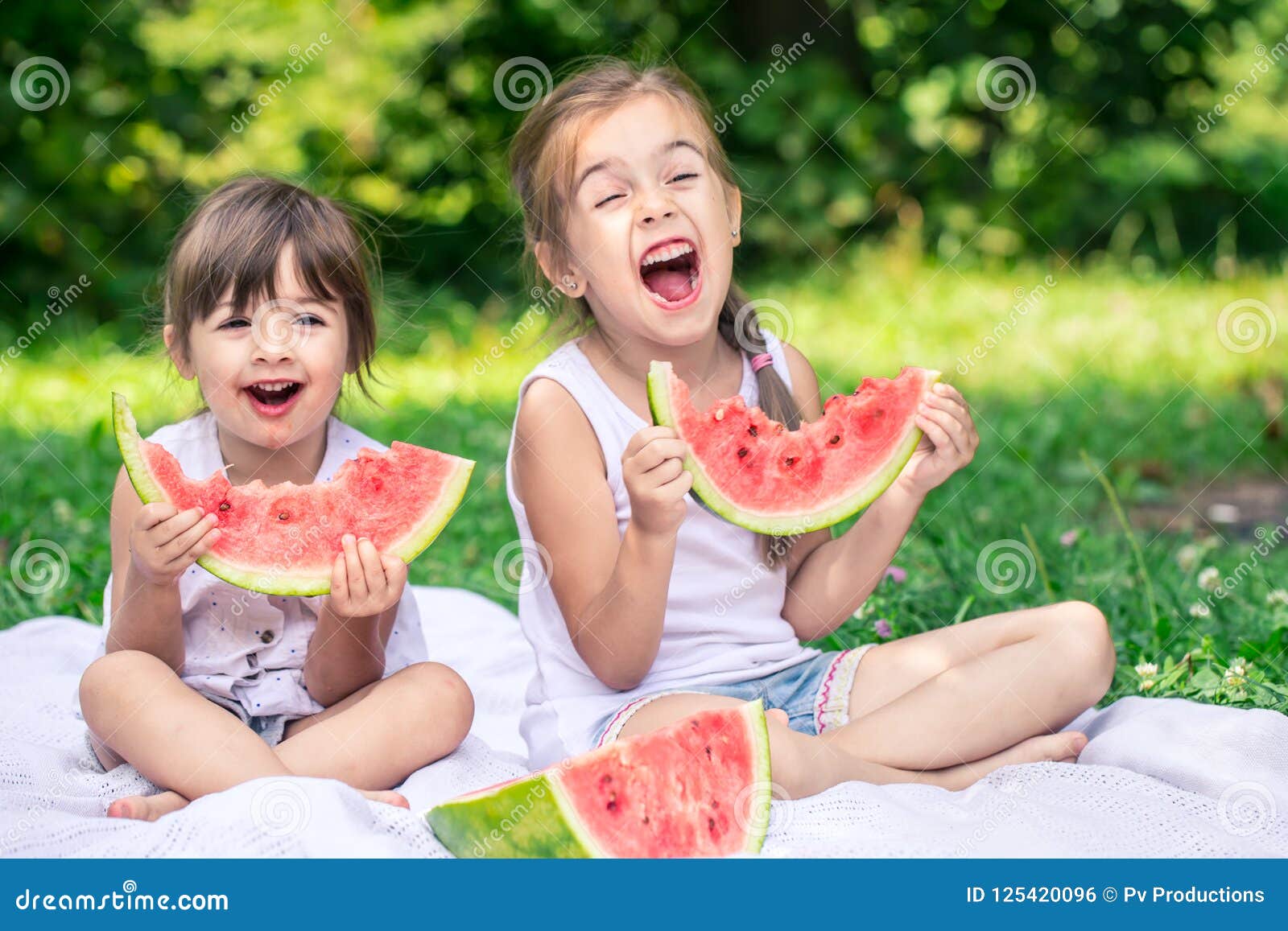 Download Two Little Cute Girls Eating Watermelon Outdoors Stock ...