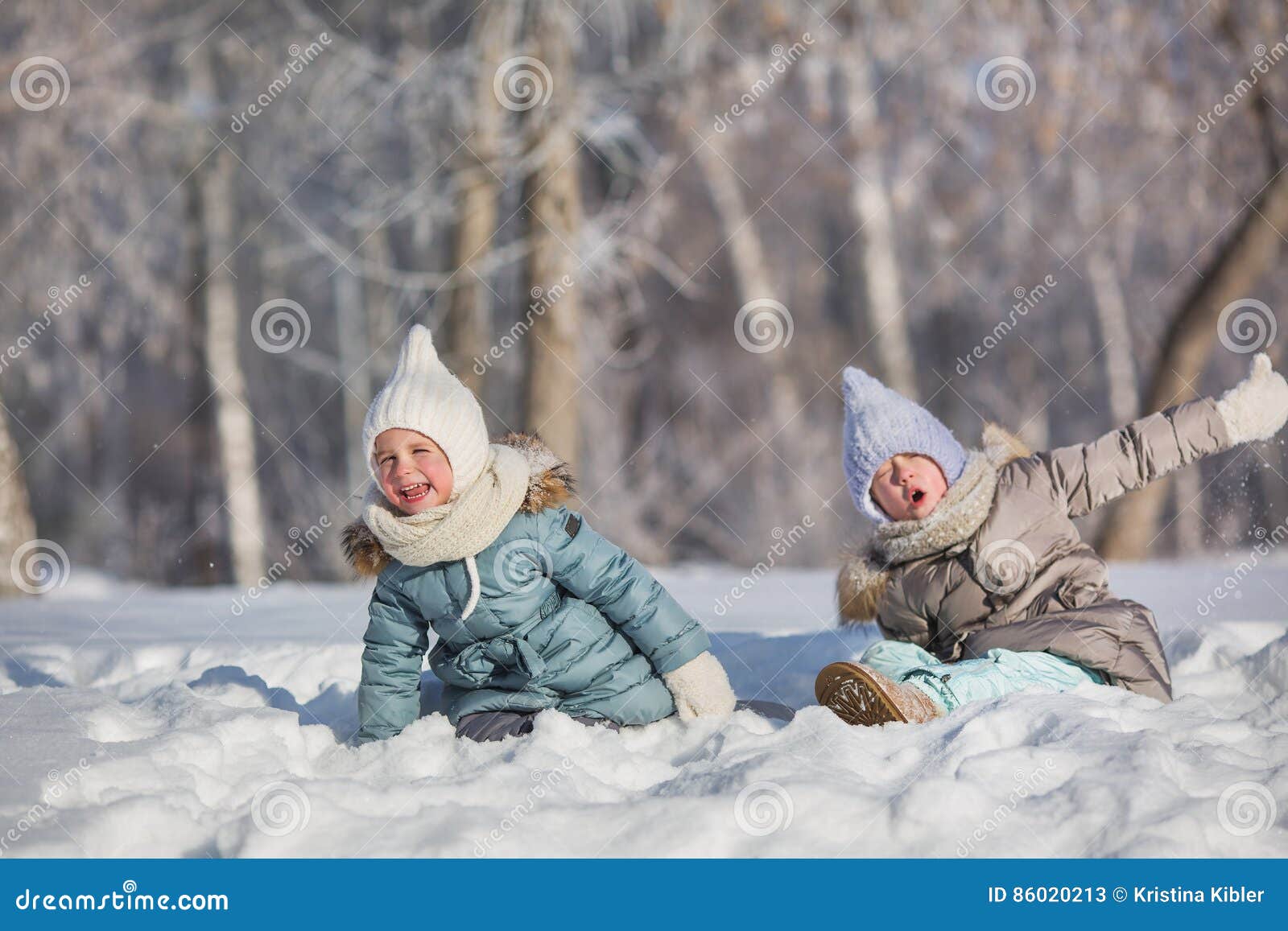 Two Little Girls Sit in Snowdrift and Make Faces in Winter Stock Image ...