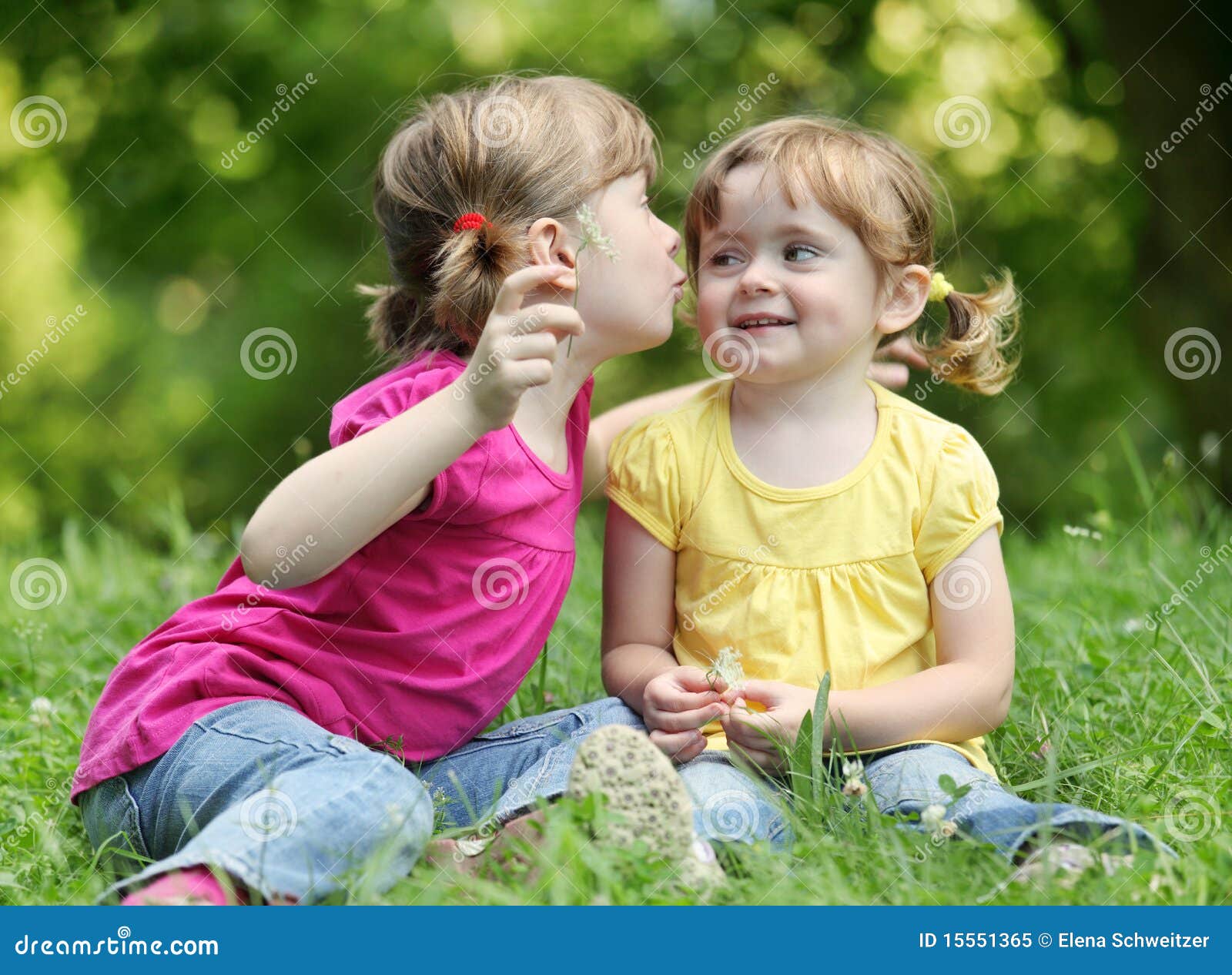 two little girls telling secrets
