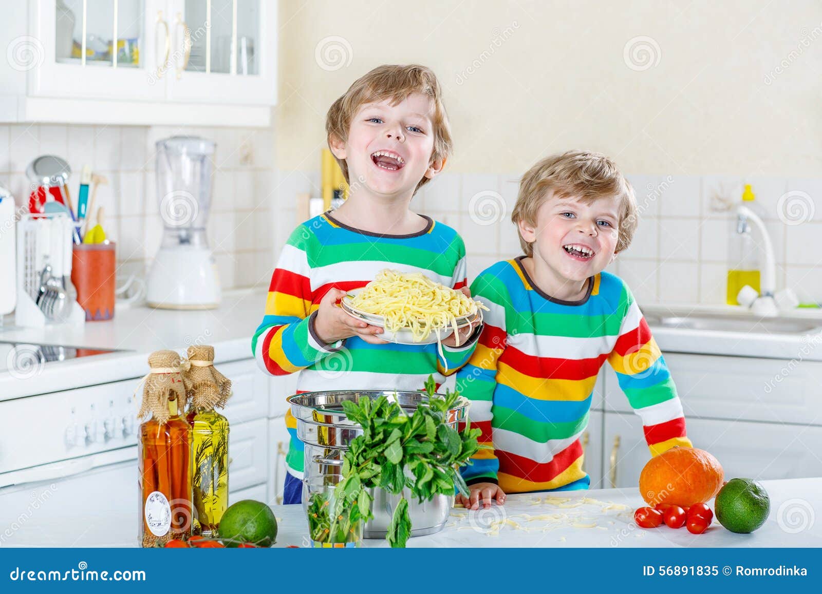 Two Little Kid Boys Eating Spaghetti in Domestic Kitchen. Stock Image ...