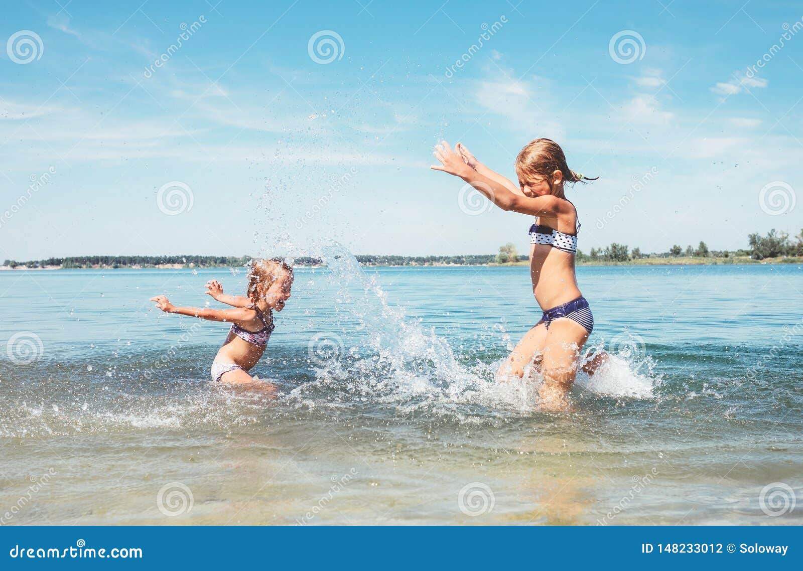Two Little Sister Girls Fooling Around in the Calm Sea Waves Splashing  Water To Each Other. Family Vacation Concept Image Stock Photo - Image of  play, little: 148233012