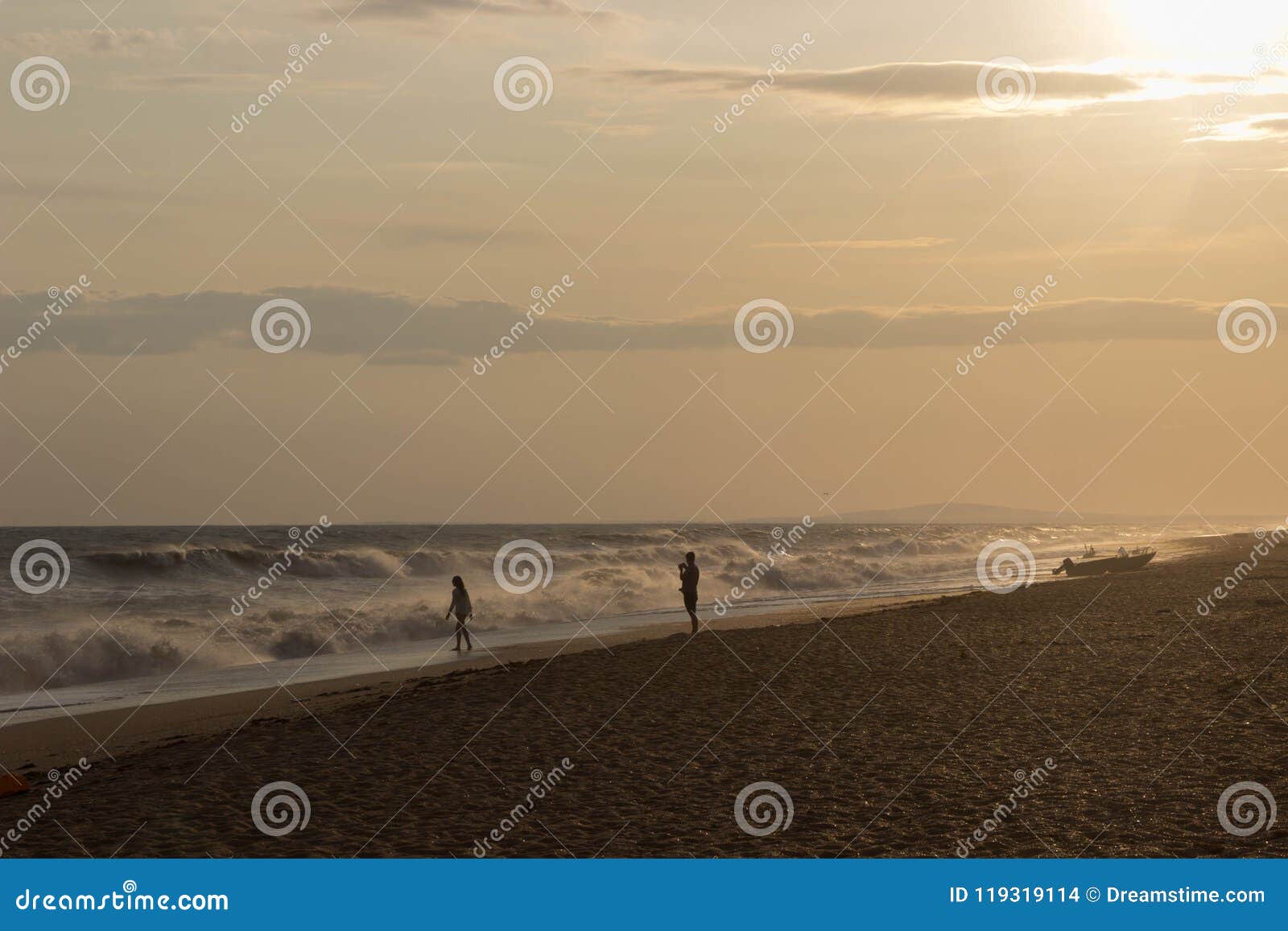 Two Lovers Walking on the Golden Beach by Lights of Sunset Near Old ...