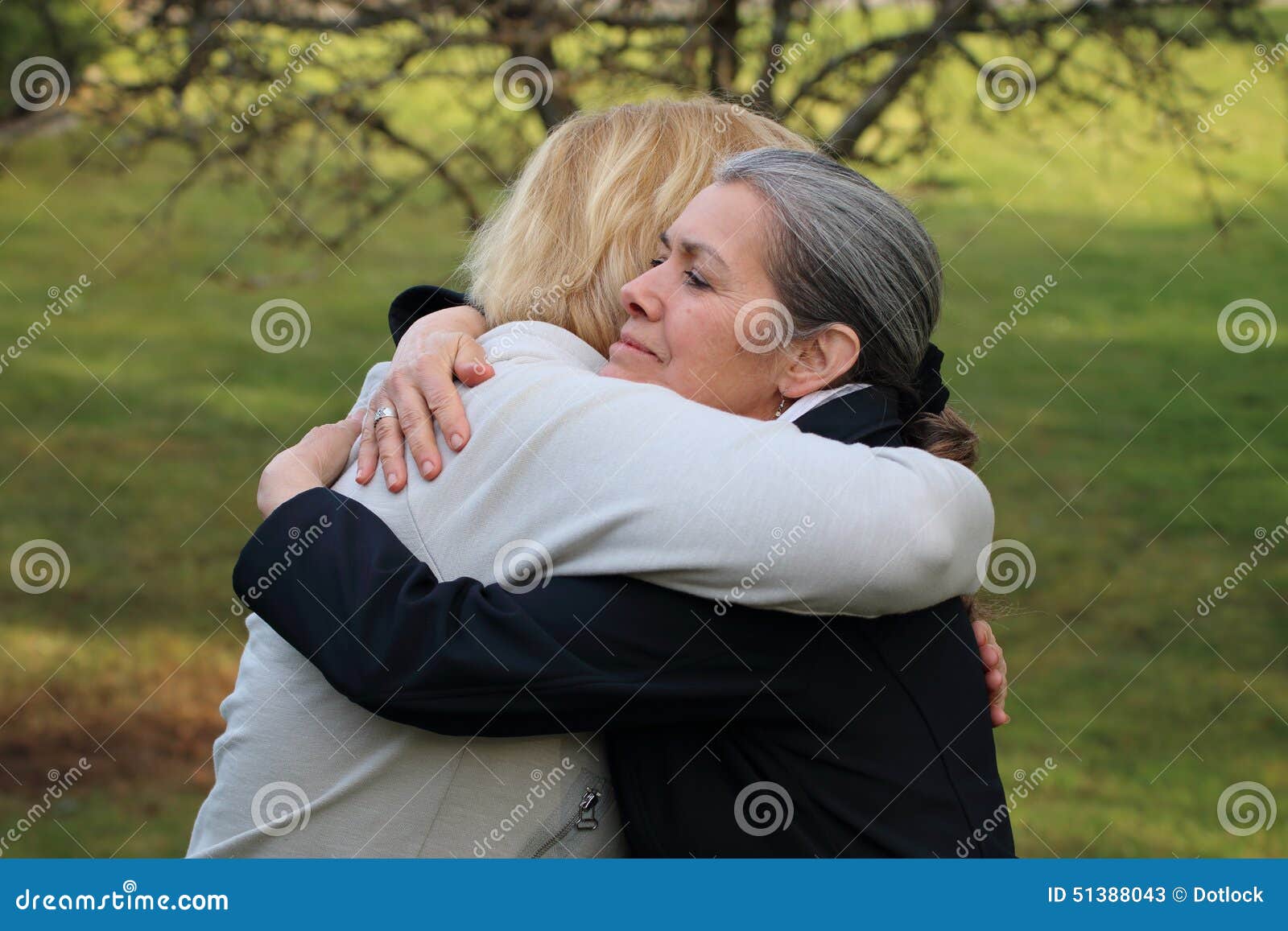 two mature friends hugging