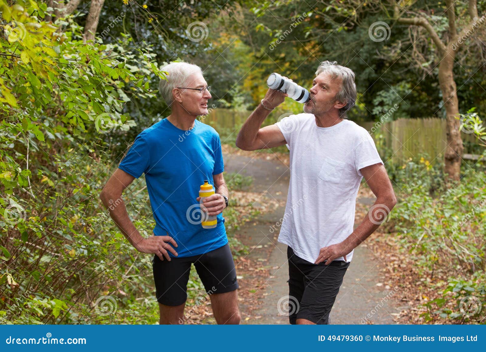 two mature male joggers taking break whilst on run