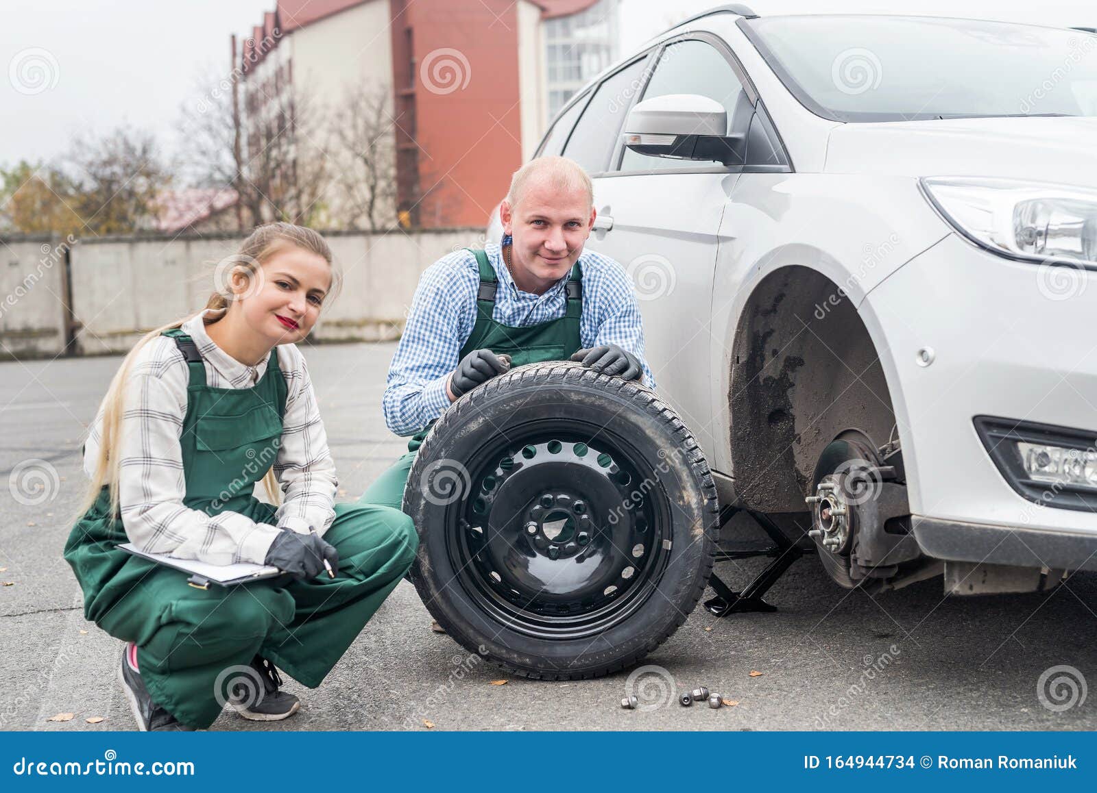 Two Mechanics at Car Service with Spare Wheel Stock Photo Image of