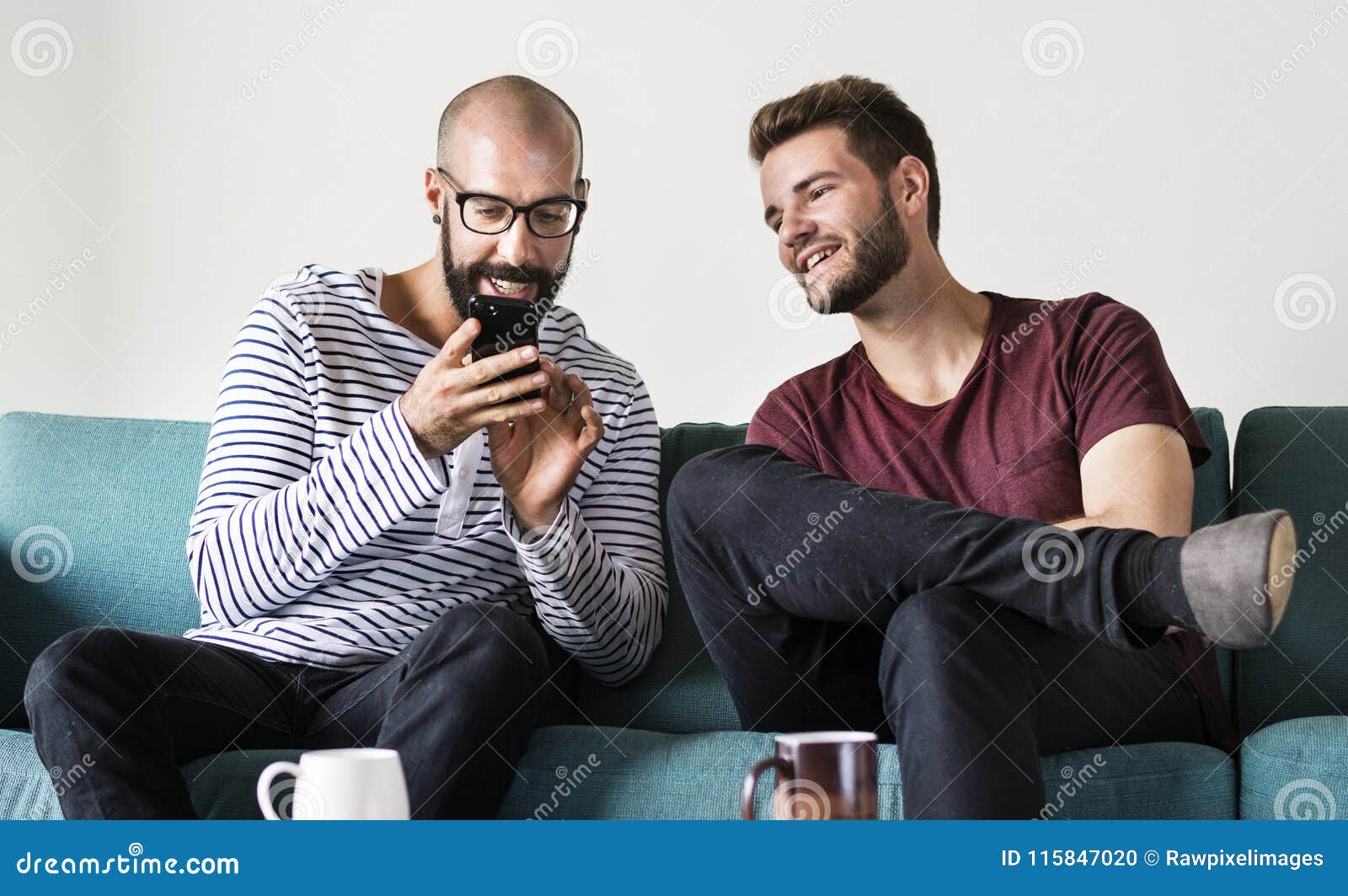 Two Men on Couch Chilling and Playing with Mobile Stock Photo Image of emotion, network 115847020