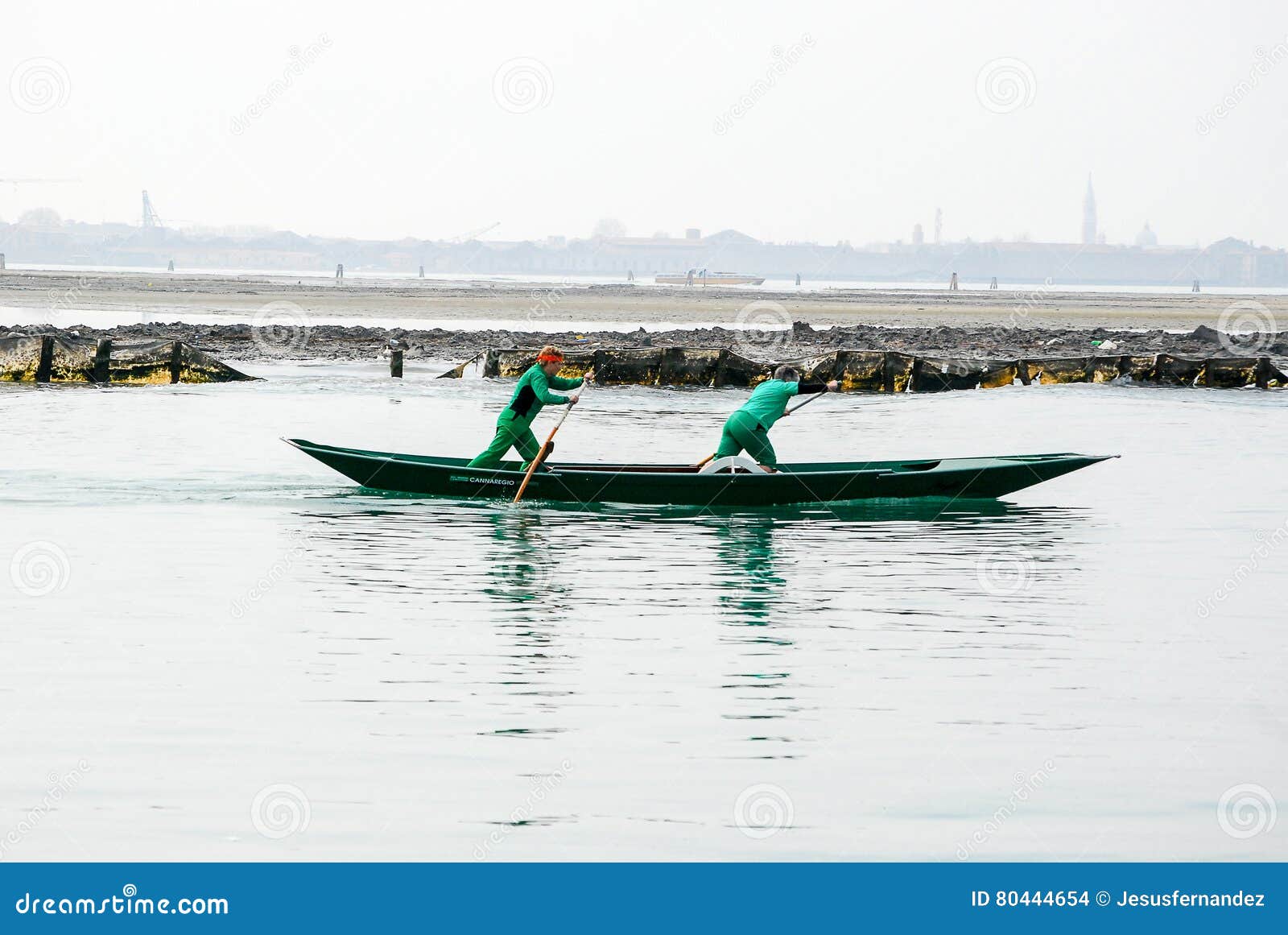 Two Men Excercise Rowing a Boat in Venice, Italy Editorial Stock Image