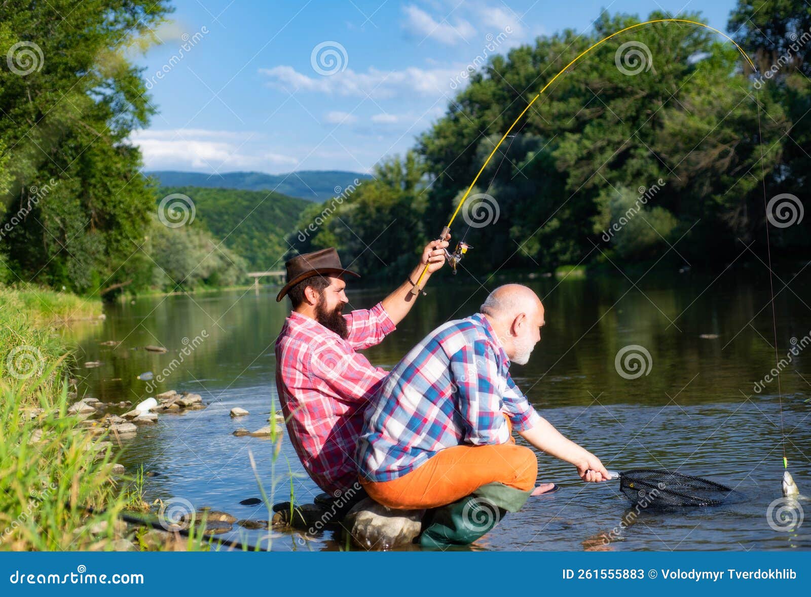 Two Men Friends Fisherman Fishing on River. Old Father and Son