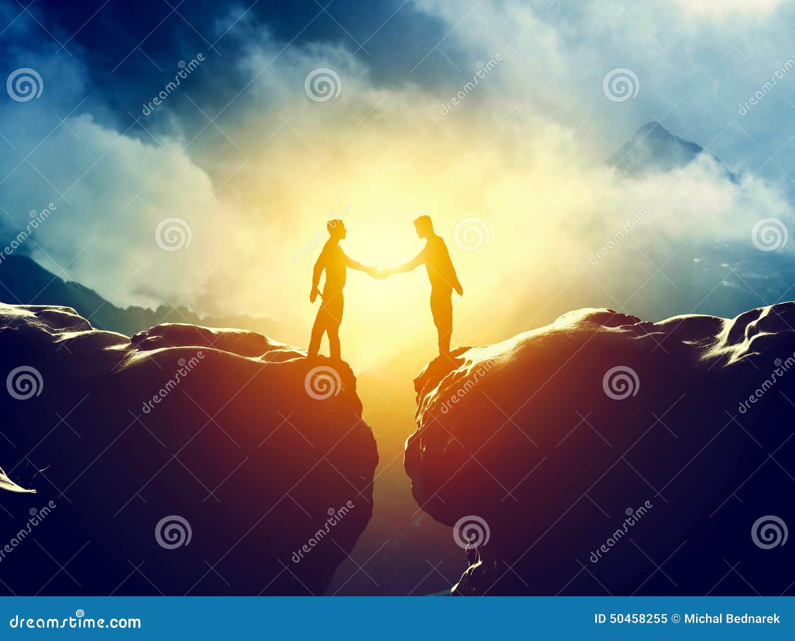 two men handshake over mountains precipice. business