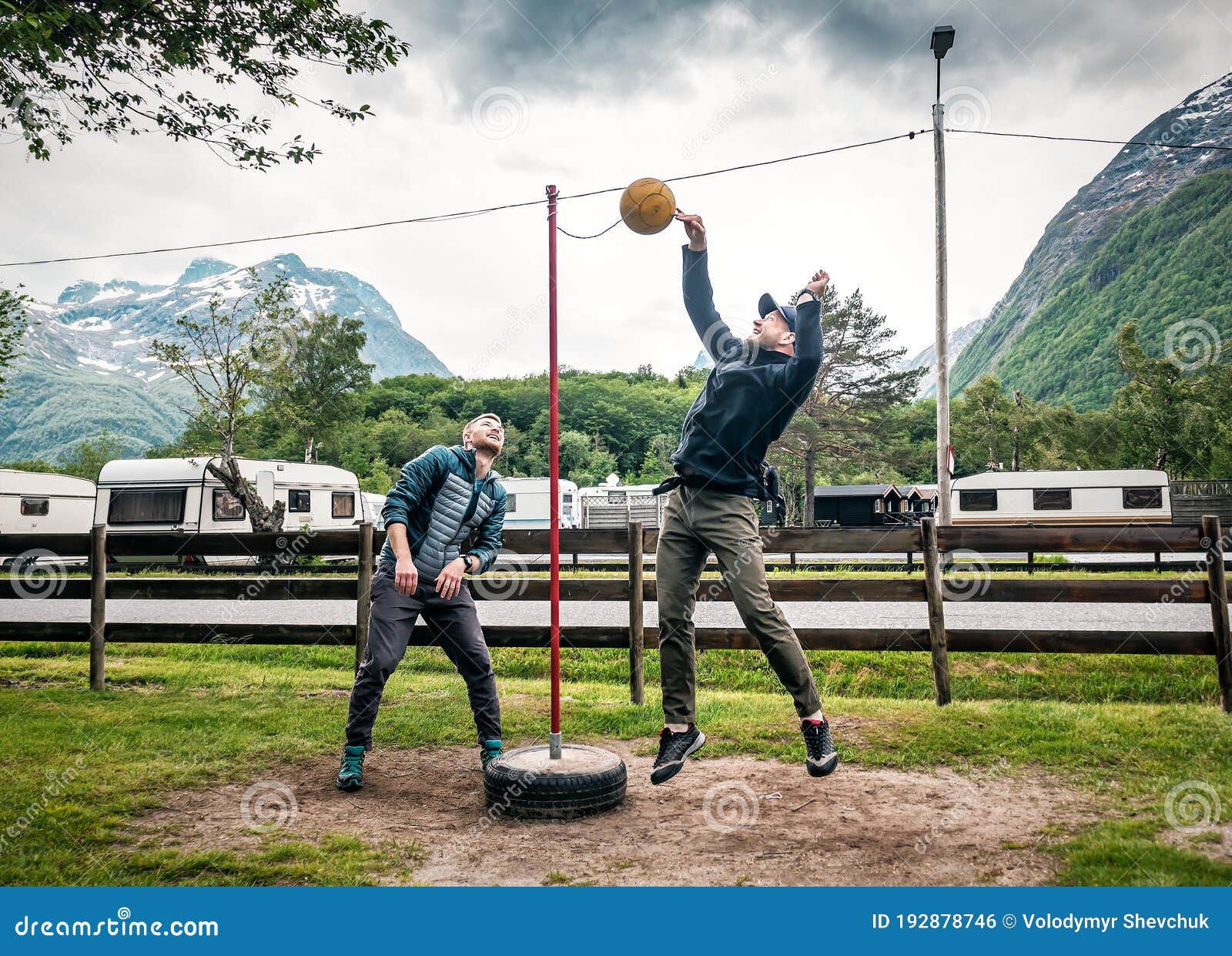 Two Men are Playing Tetherball Game Stock Photo - Image of game, sand:  192878746