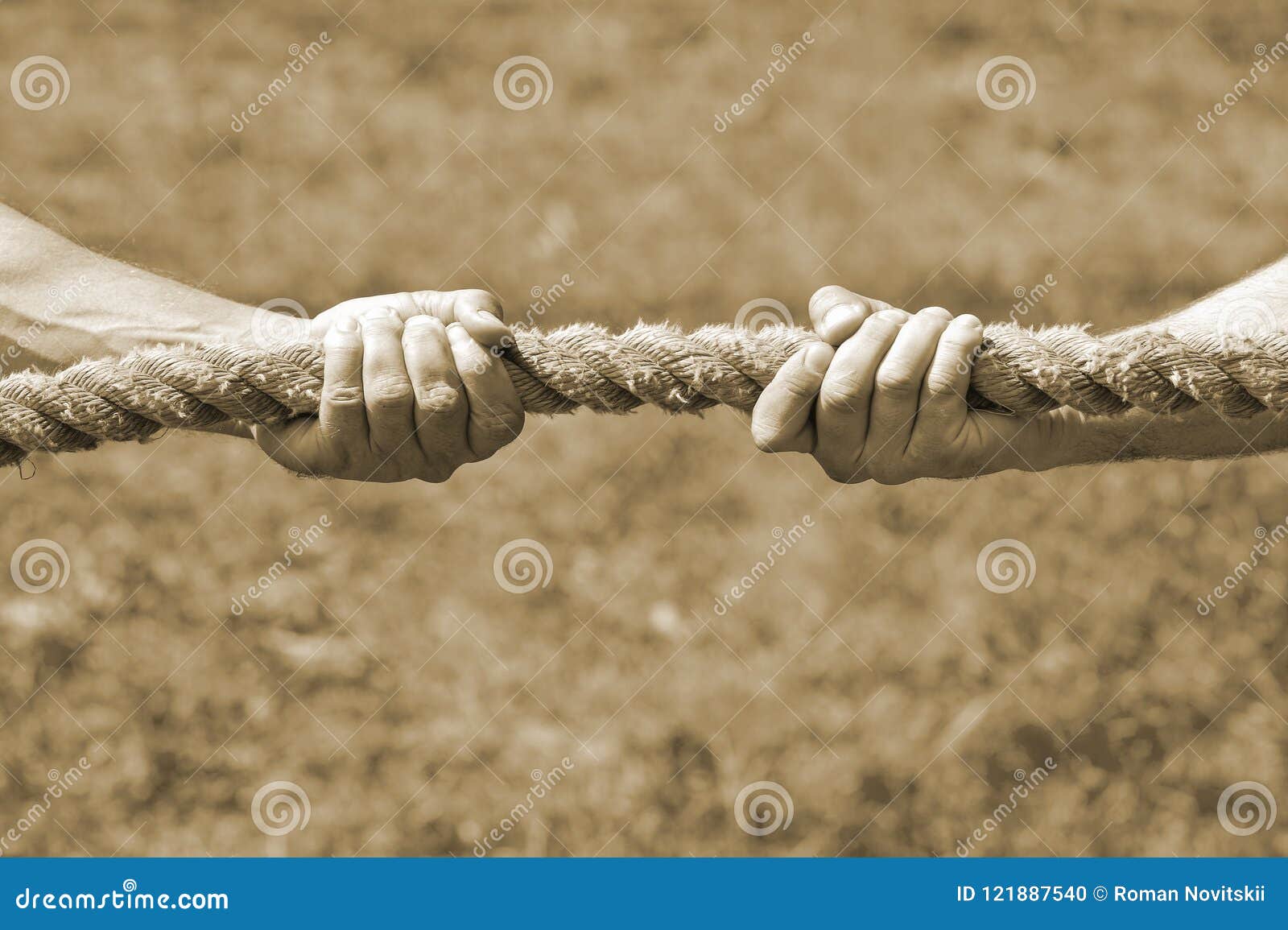 Two Men`s Hands Pull the Rope Each in His Own Direction. the Concept of