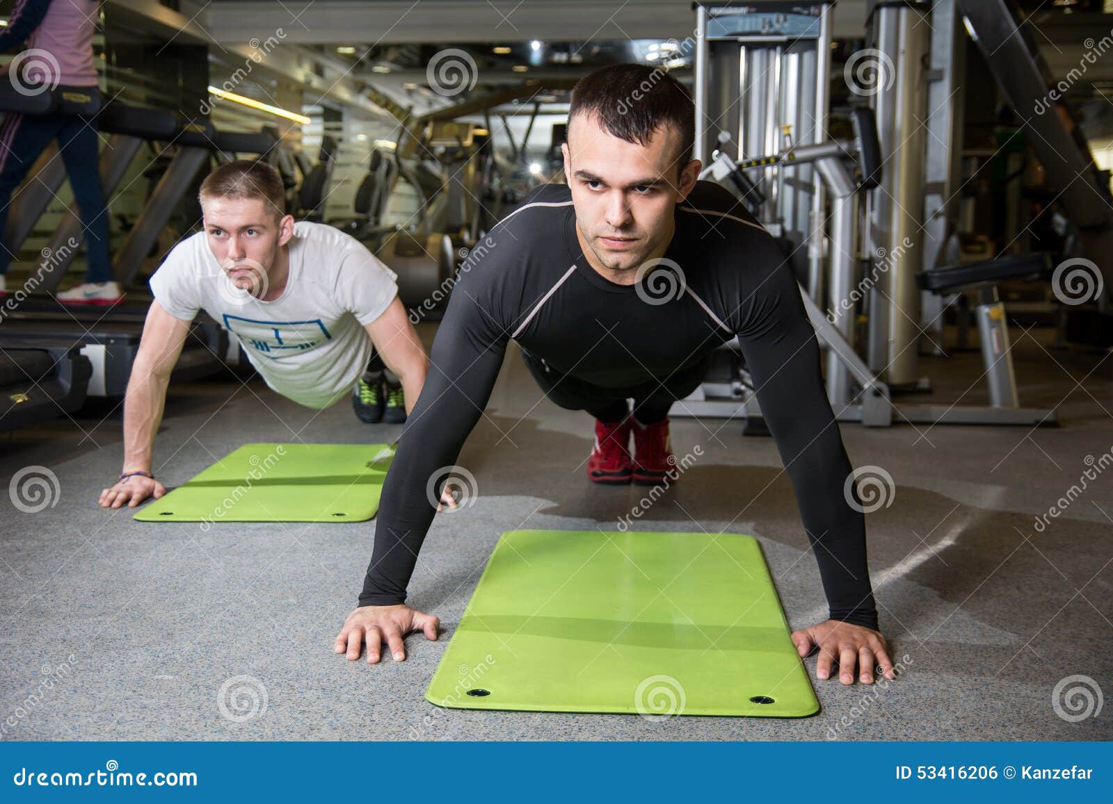 Two Men Working on Exercise Mat in Fitness Studio. Stock Photo Image