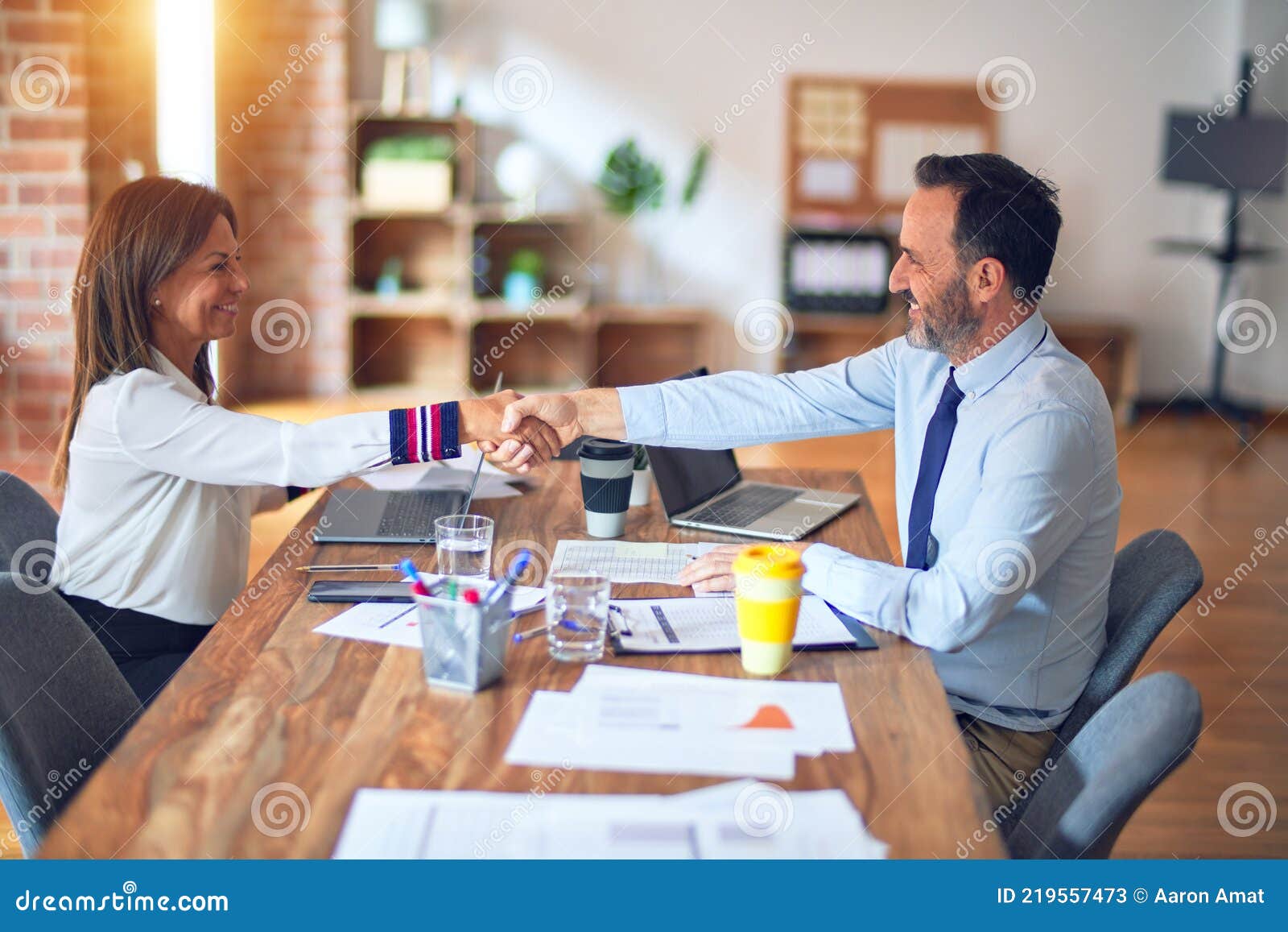 two middle age business workers smiling happy and confident