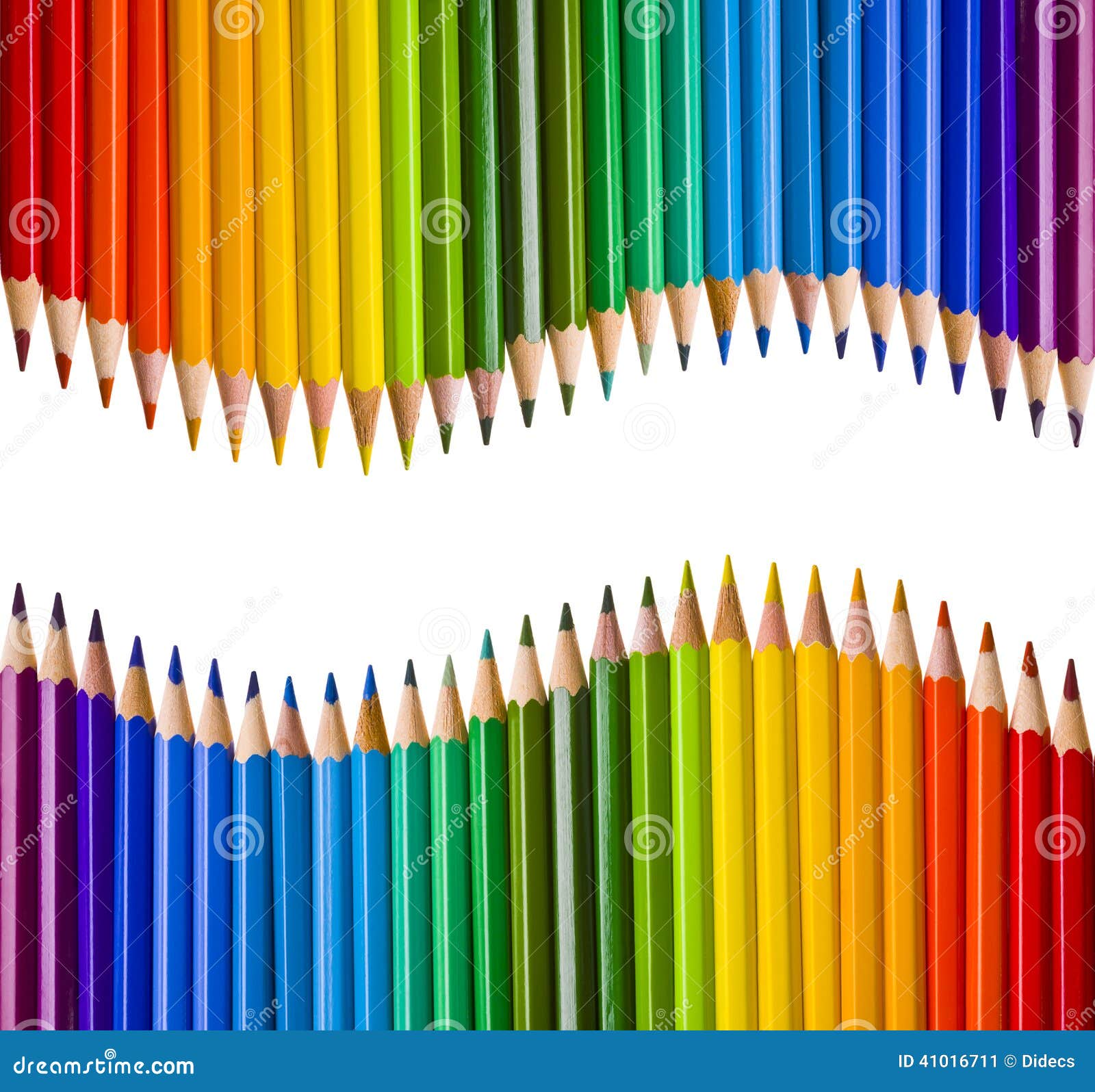 Two mirrored waves of colorful pencils on white