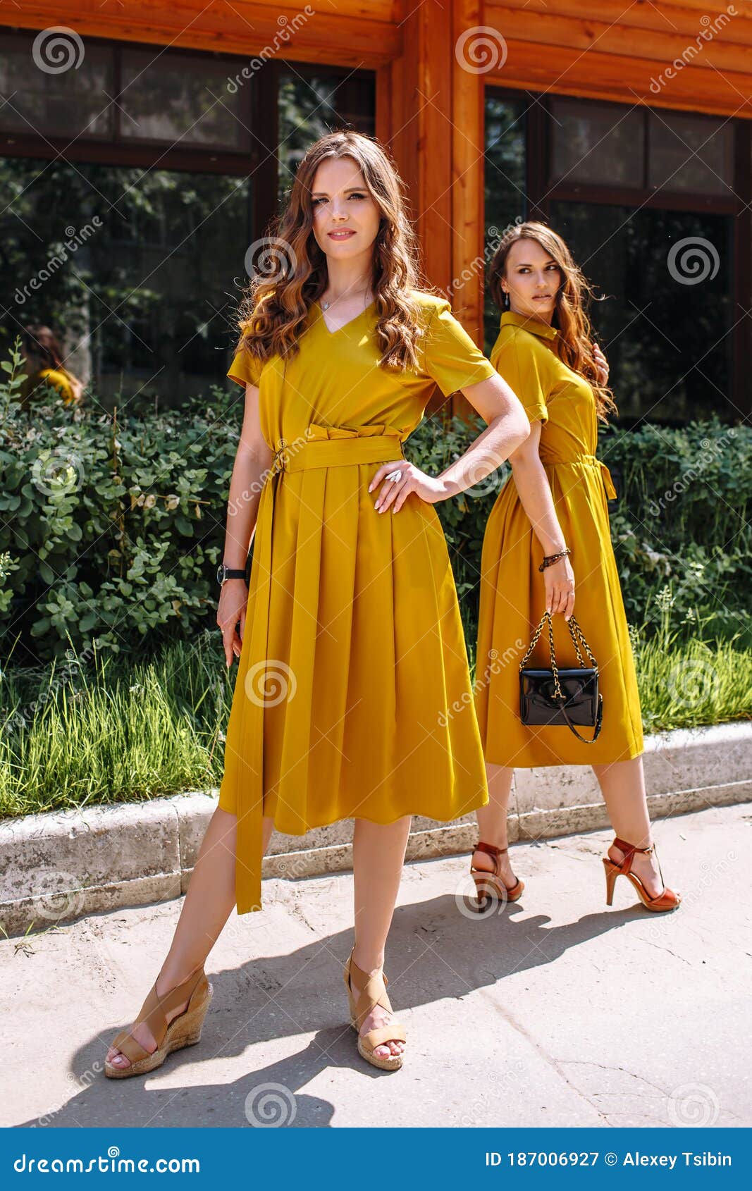 Two Models on the Street in Mustard Colored Dresses Stock Image - Image ...