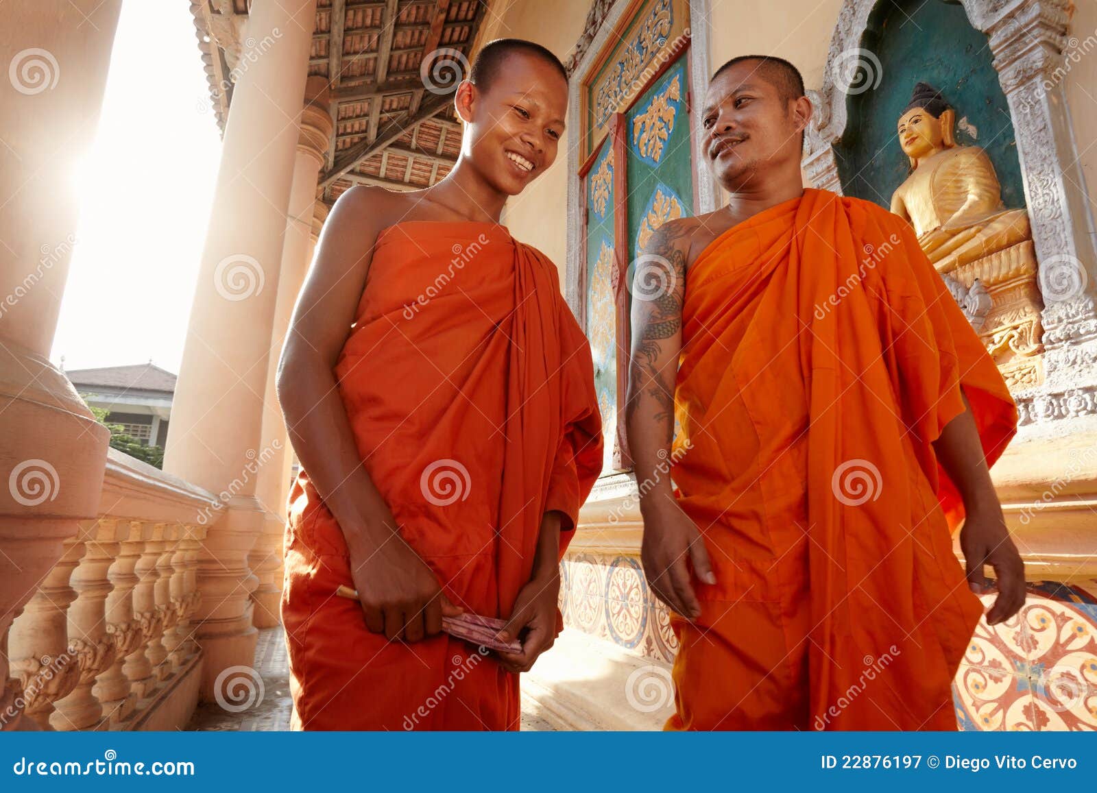 two monks walk in a buddhist monastery, asia