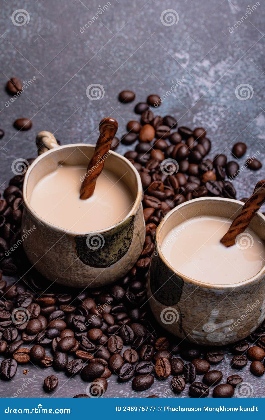 Two Mugs of Coffee with Coffee Beans on a Dark Backdrop Stock Image